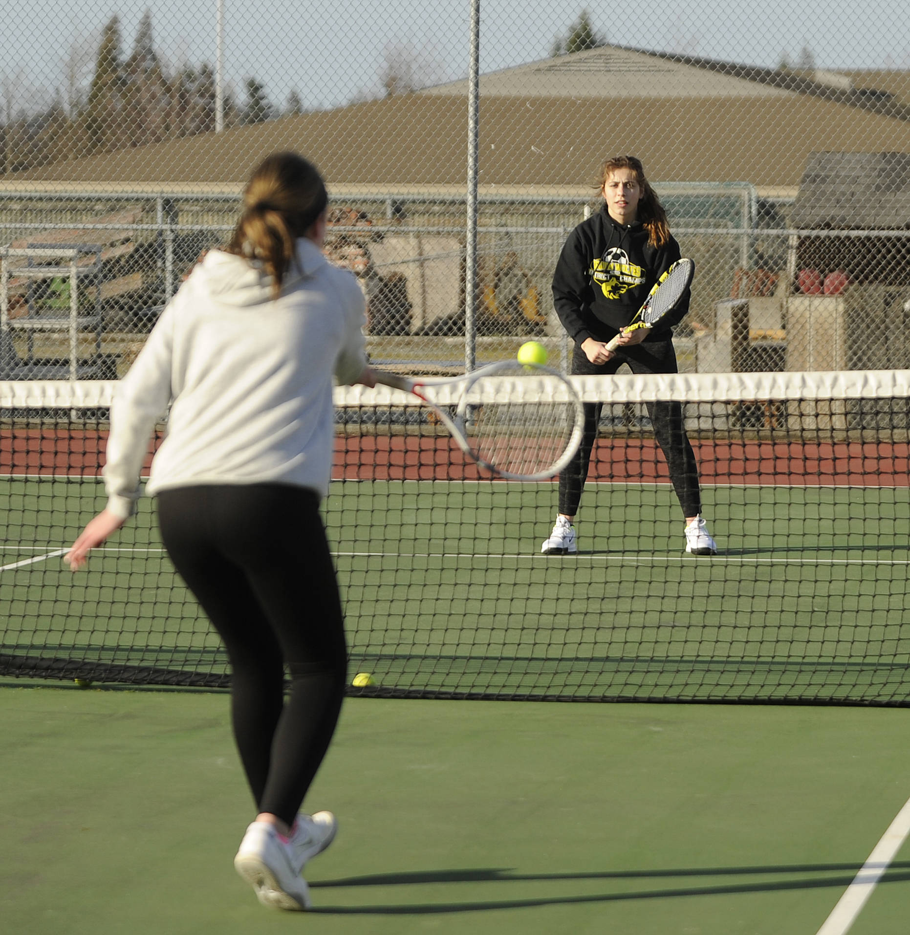 Doubles team partners Kalli Wiker (foreground) and Jessica Dietzman, pictured at a preseason practice in early March, looked to defend their 2A title this spring; the 2019-2020 school year closure ended their season before it began and ended Dietzman’s prep sports career. Sequim Gazette file photo by Michel Dashiell