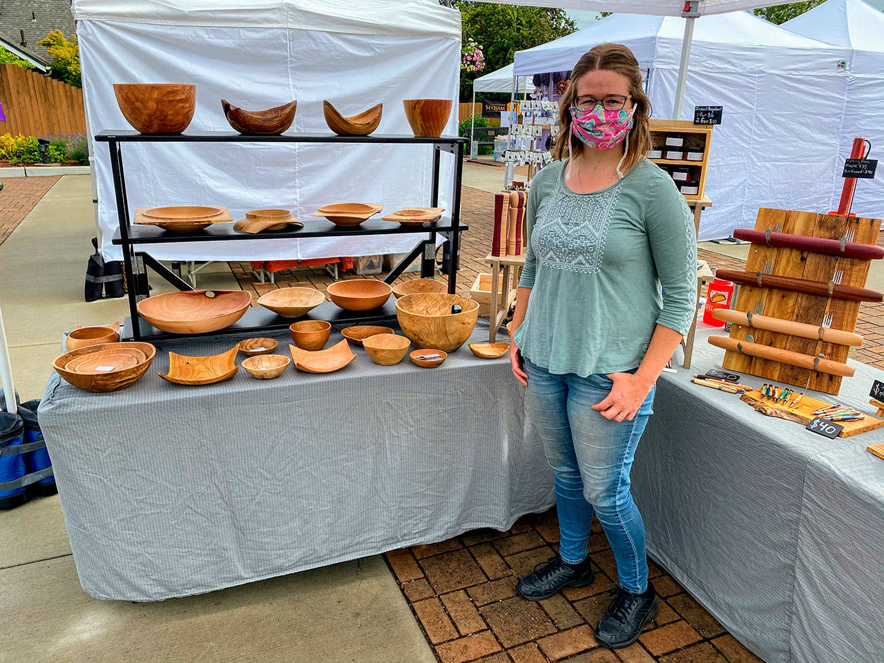 Jennifer Stevenson, right displays Northwest Beach Works wares at the Sequim Farmers & Artisans Market. Photo by Emma Jane Garcia