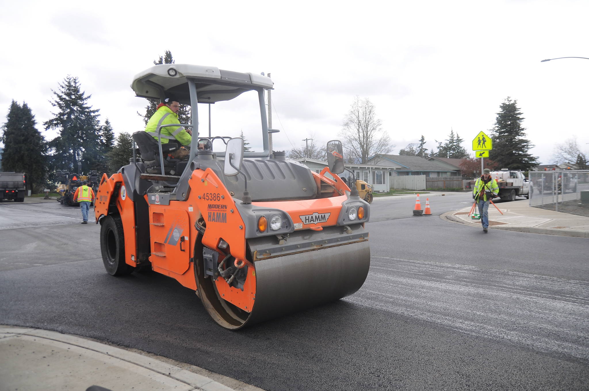 Crews from Lakeside Industries and Interwest Construction pave West Fir Street in late March. The City of Sequim hosts a ribbon cutting on July 9 to celebrate the project’s completion. Sequim Gazette file photo by Michael Dashiell