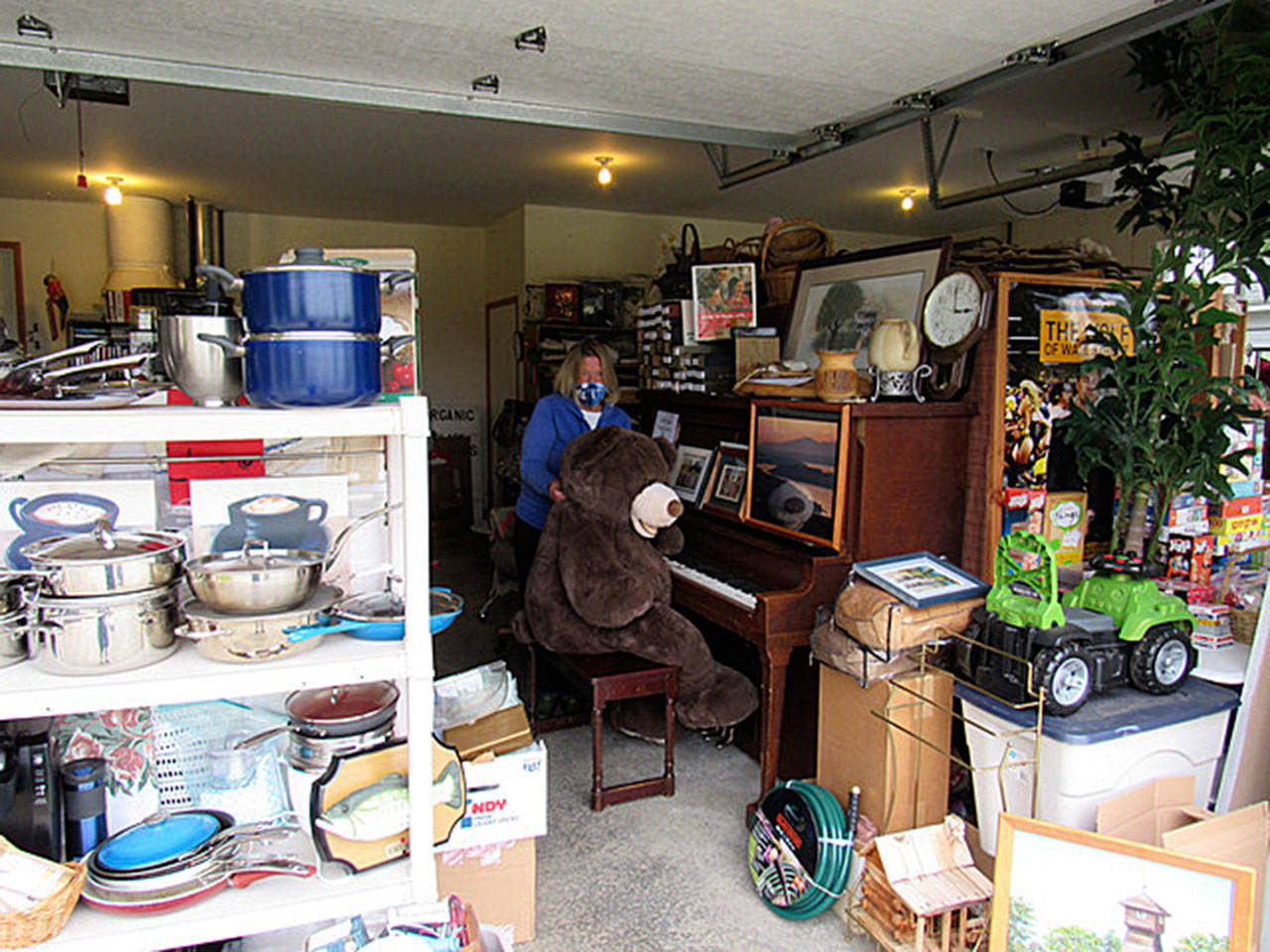 Carol Labee organizes items at the site of the Sequim Guild of Seattle Children’s Hospital’s 13th-annual Garage & Plant Sale, set for July 24-25. Submitted photo