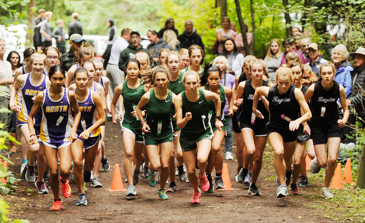 Runners from Sequim, Port Angeles and North Kitsap girls cross country squads break from the starting line at Robin Hill County Park at an Olympic League meet in 2019. All of the Olympic League’s 2020 fall sports — including cross country — have been moved to spring 2021. Sequim Gazette file photo by Michael Dashiell