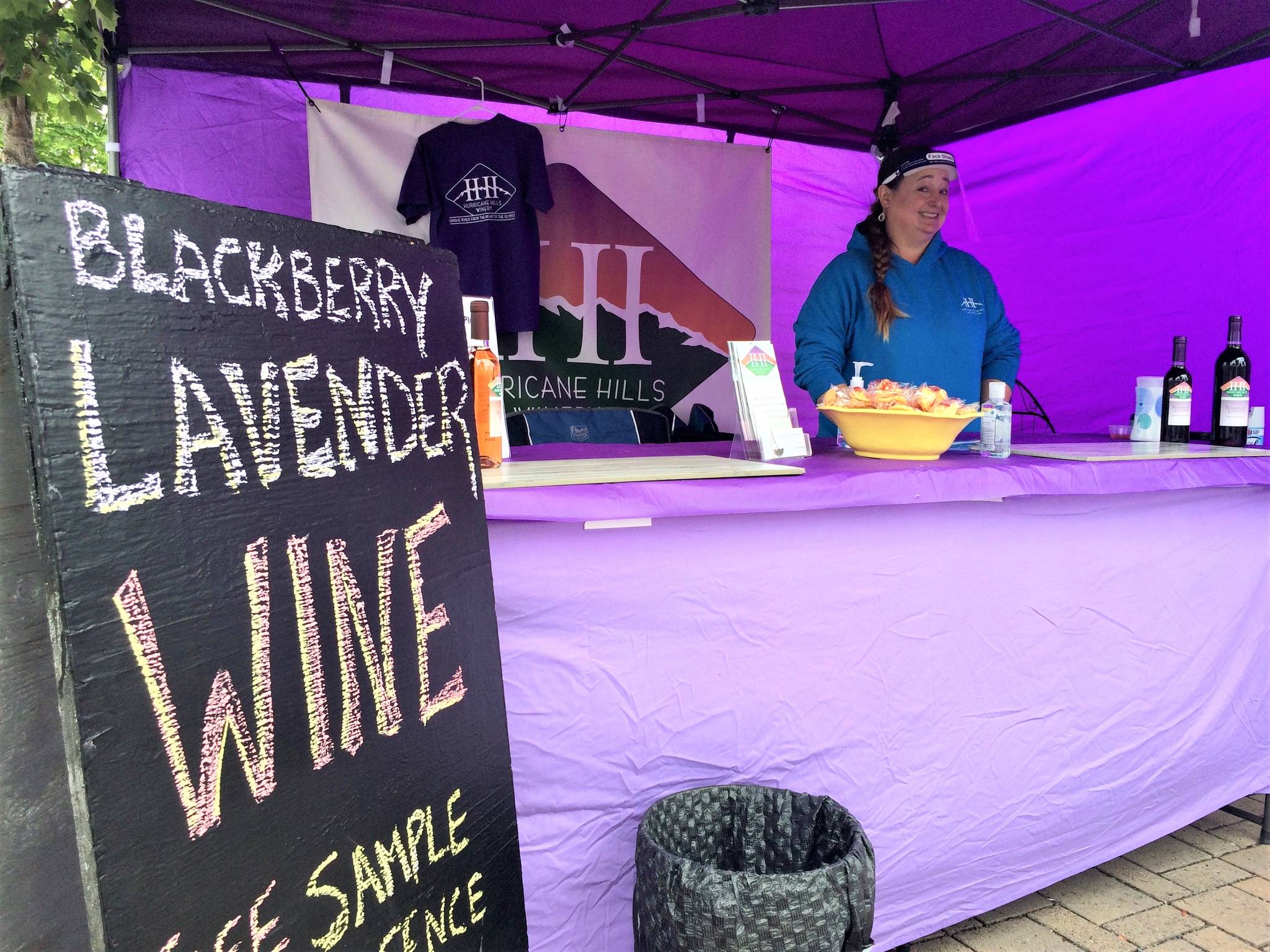 Jessie Newberg of Hurricane Hills Winery greets customers at the Sequim Farmers & Artisans Market. Photo by Emma Jane Garcia