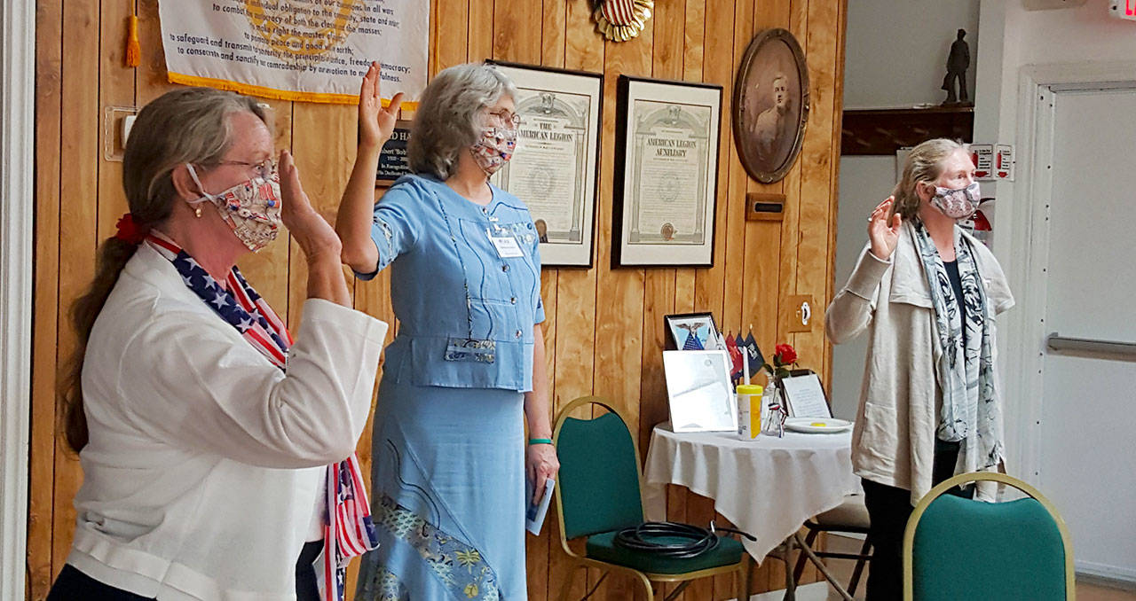 From left: Ellen LaMarr, Marianne Burton and Lisa Stoddart take the Oath of Membership as they join Michael Trebert Chapter-Daughters of the American Revolution. Photo by Sandy Frykholm