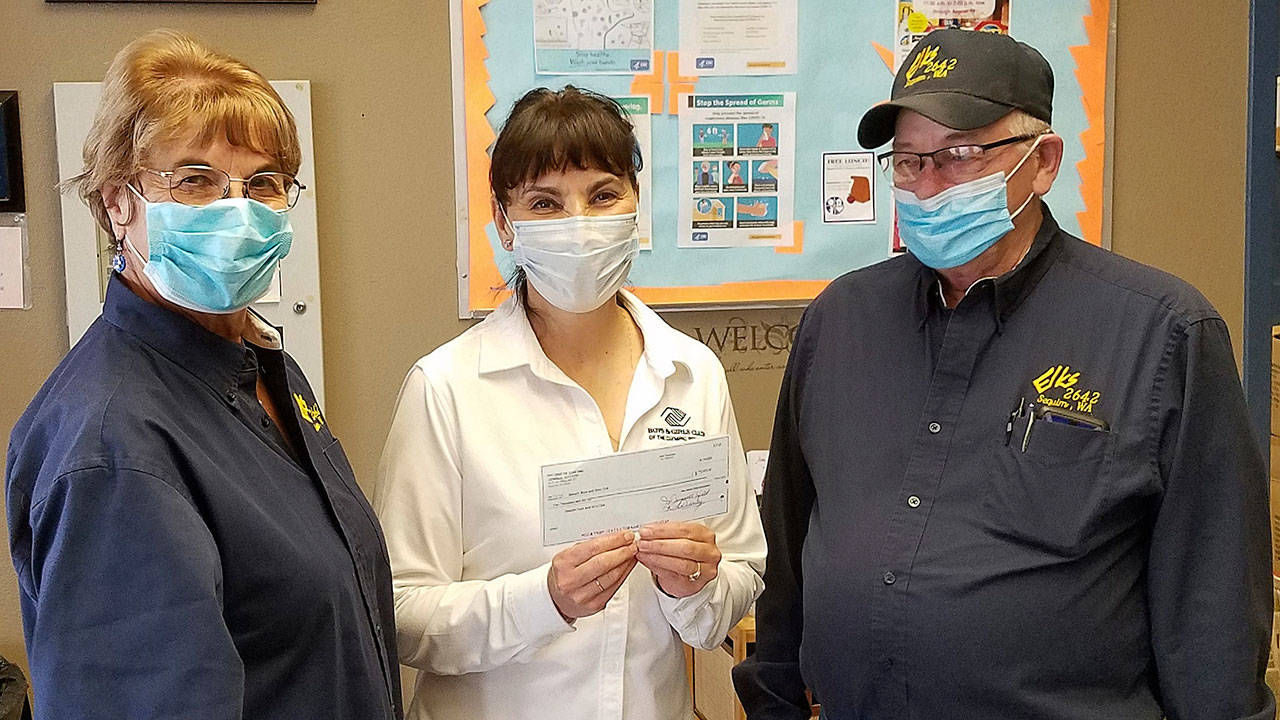 Mary Budke, executive director of the Boys & Girls Clubs of the Olympic Peninsula (center), accepts a $2,000 grant from the Sequim Elks Lodge 2642, represented her by charities chair Maura Mattson and Sequim Elks Exalted Ruler Charlie Johnson. Submitted photo