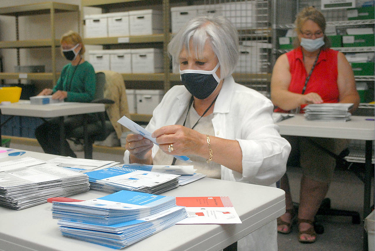 Election worker Connie Miller of Port Angeles, center, along with co-workers Nancy Mills of Port Angeles, left, and Jam Janni of Sequim, right, open ballots for the primary election at the Clallam County Courthouse in Port Angeles on Aug. 4. Ballots for the Nov. 3 general election go into the mail for Clallam County voters today, Oct. 14. File photo by Keith Thorpe/Olympic Peninsula News Group