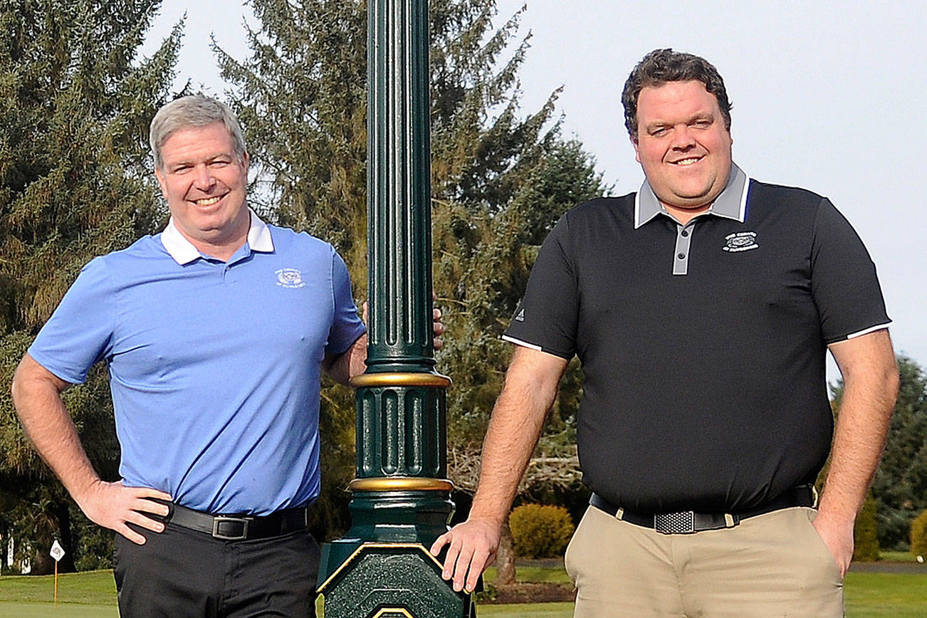 At left, Bill Shea, general manager and director of golf operations, and head professional Garrett Smithson celebrate 10 years of 7 Cedars Casino’s ownership of The Cedars at Dungeness in December 2016. After 23 years working for the tribe, Smithson stepped down from his role this month as he makes a career change. Sequim Gazette file photo by Michael Dashiell