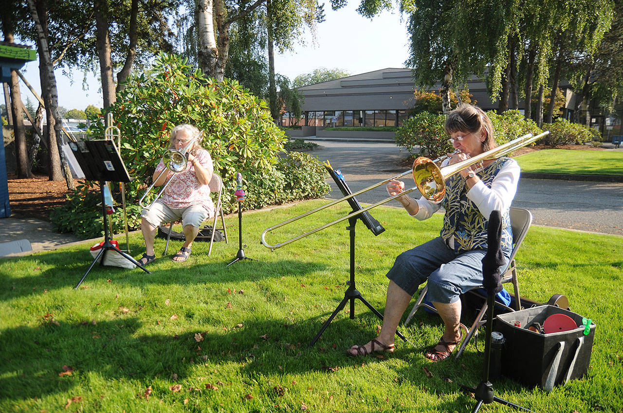 Above: Bonnie Booth, left, and Cindy MacKay play duets in the park near the intersection of Sequim Avenue and Washington Street on Oct. 2. Left: Helen Bucher, a lifelong Sequim resident and former Irrigation Festival Grand Pioneer (2015), celebrates her 90th birthday with some accordion playing at the Railroad Bridge Park on Oct. 1. Sequim Gazette photos by Michael Dashiell