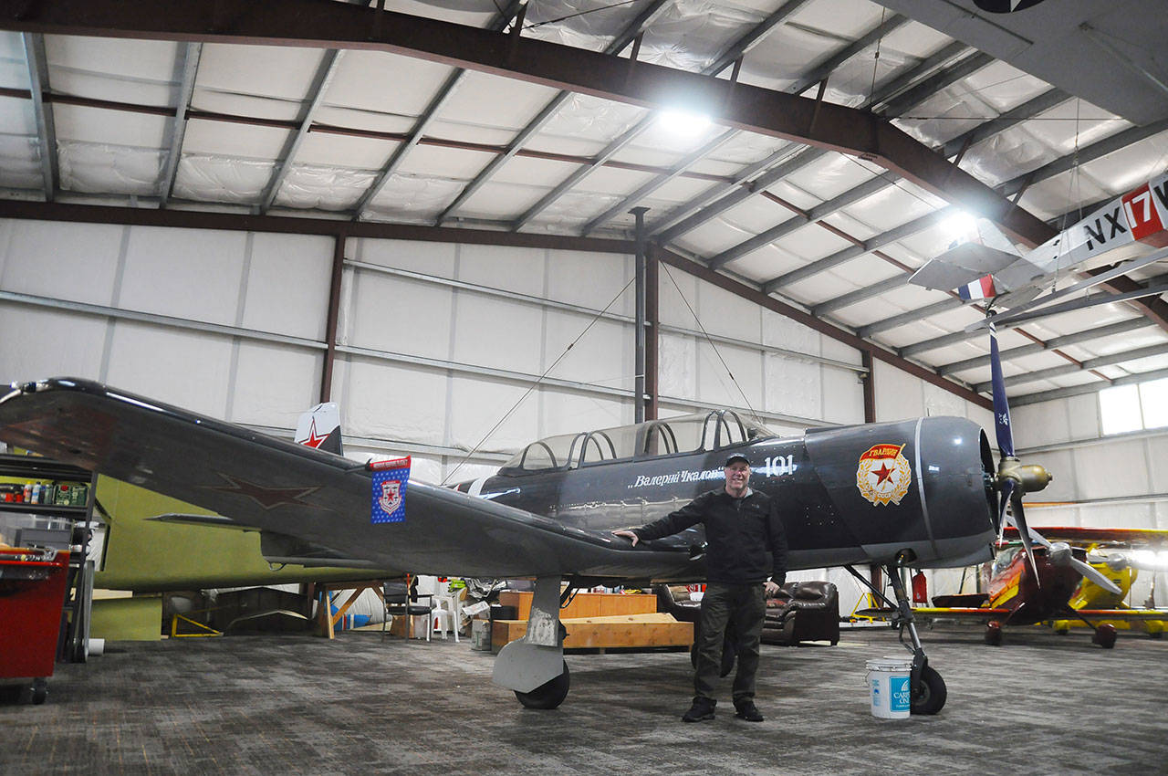 Andy Sallee stands by his son Daniel’s plane in the large hangar at Sequim Valley Airport in early November. The airport is for sale, Sallee says, with he and other stockholders seeking new owners who will keep the same community feel. Sequim Gazette photo by Michael Dashiell