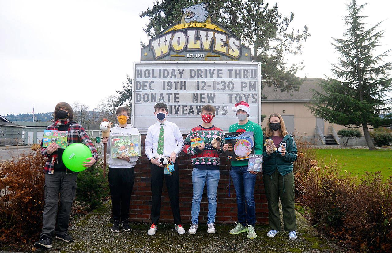 From left, Sequim High leadership students Richard Meier, Erik Holtrop, Dustan Koch, Aidan Braaten, Kaleb Needoba and Hannah Hampton make plans for a special holiday-themed drive-thru and toy drive, slated for noon-1:30 p.m. Saturday, Dec. 19, at the high school. Sequim Gazette photo by Michael Dashiell