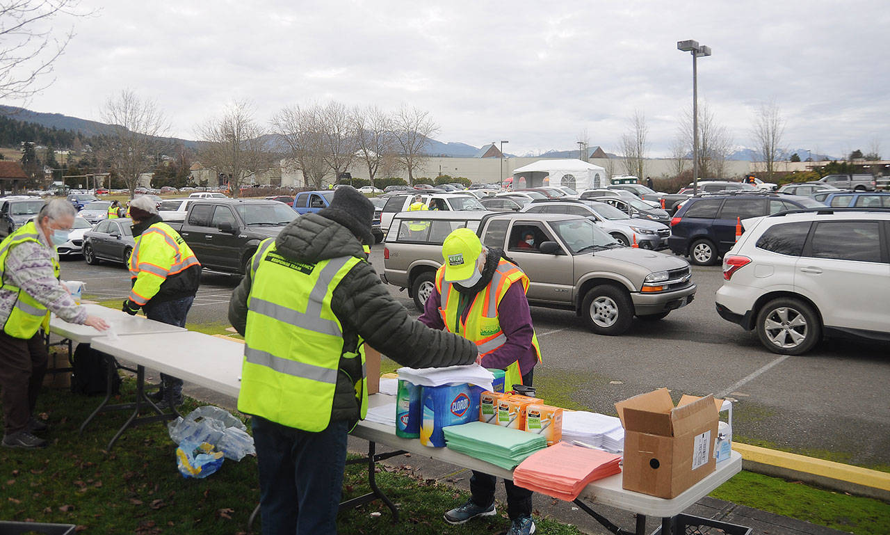 Members of the Community Emergency Response Team organize material at the registration checkpoint of the Jamestown S’Klallam Tribe’s COVID-19 vaccination clinic on Jan. 14. Beginning Feb. 2 and set for that date, Feb. 4 and Feb. 6, the clinic will be by appointment only at vaccine.clallam.net/register. Sequim Gazette file photo by Michael Dashiell