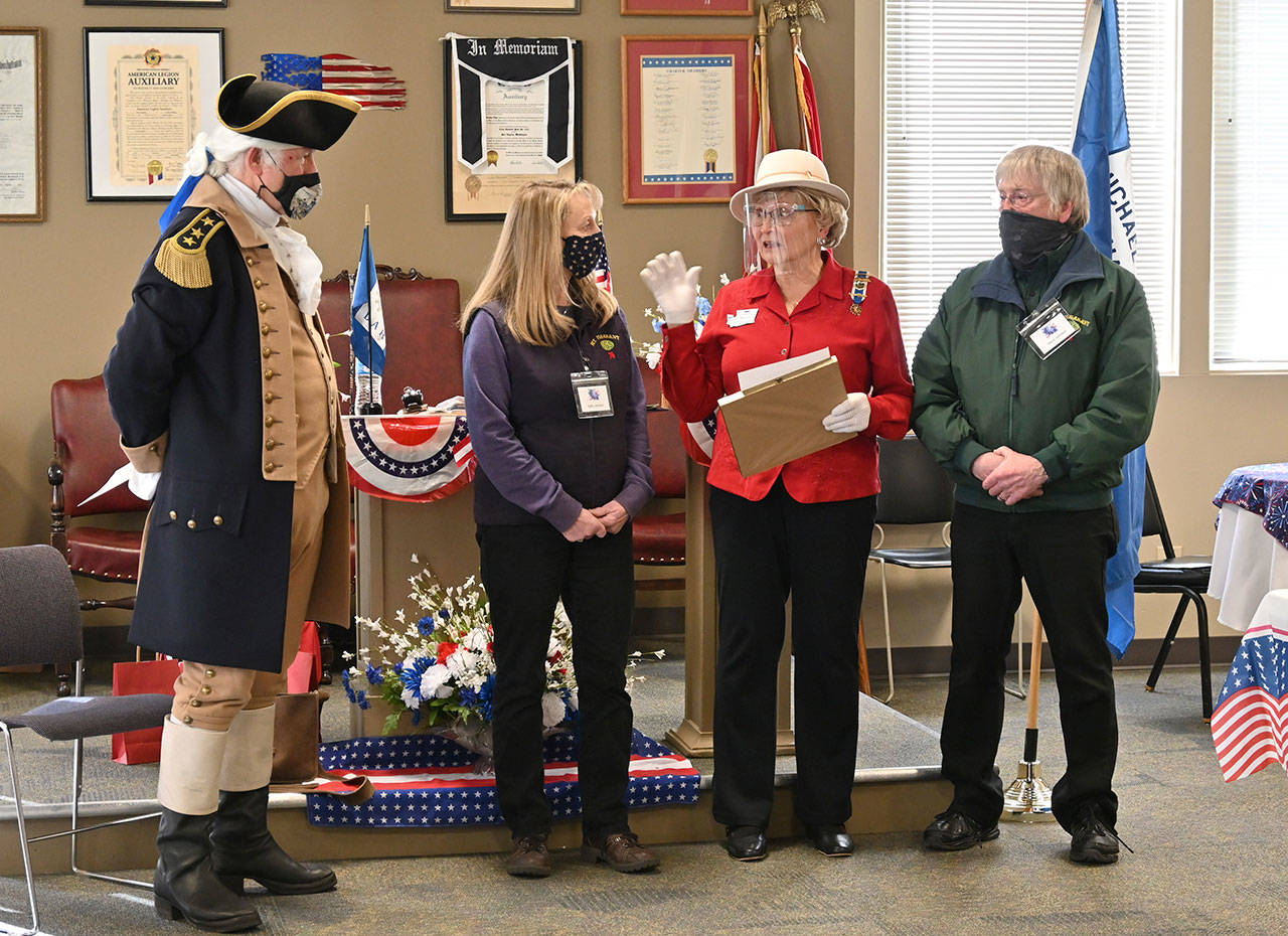 Kathy and Glenn Johnson (third from right, far right) of Mt. Pleasant I.G.S Store in Port Angeles accept an award from the Michael Trebert Chapter of the Daughters of the America Revolution on Feb. 17 in Port Angeles, at the group’s annual ““George Washington” Tea. Second from right, Carol Weiler — the chapter’s Recognition Tea Committee Chair — presents the Johnsons with the award, with Gen. George Washington (Vern Frykholm Jr.) looking on. Sequim Gazette photo by Michael Dashiell