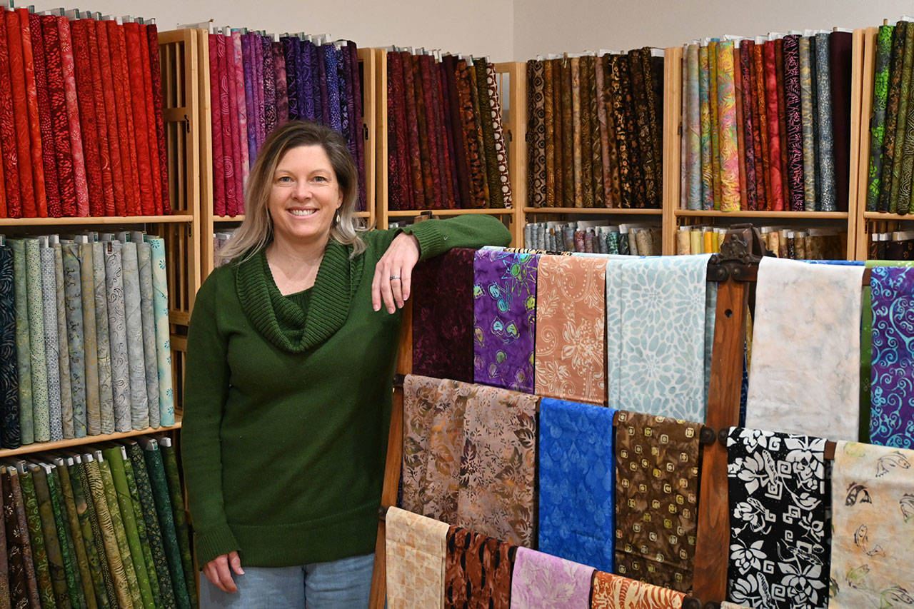 Nicole Driggs stands inside A Stitch in Time Quilt Shoppe, which opens this week on the 200 block of East Washington Street. Sequim Gazette photos by Michael Dashiell