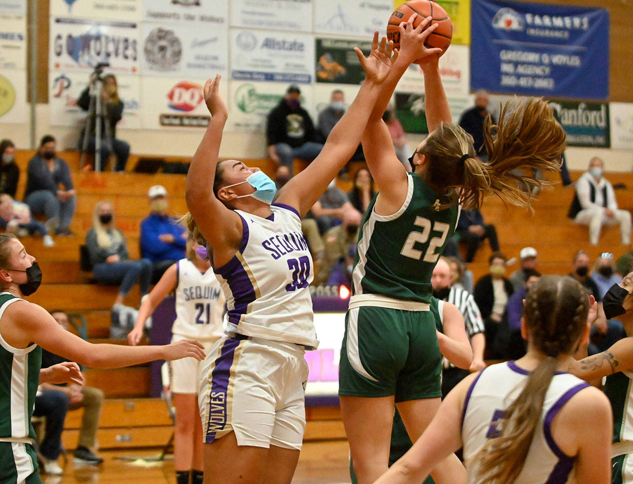 Sequim’s Jayla Julmist (30) vies for a rebound with Port Angeles’ Eve Burke in an Olympic League game in Sequim on May 12. Port Angeles topped the host Wolves, 67-58. Sequim Gazette photo by Michael Dashiell