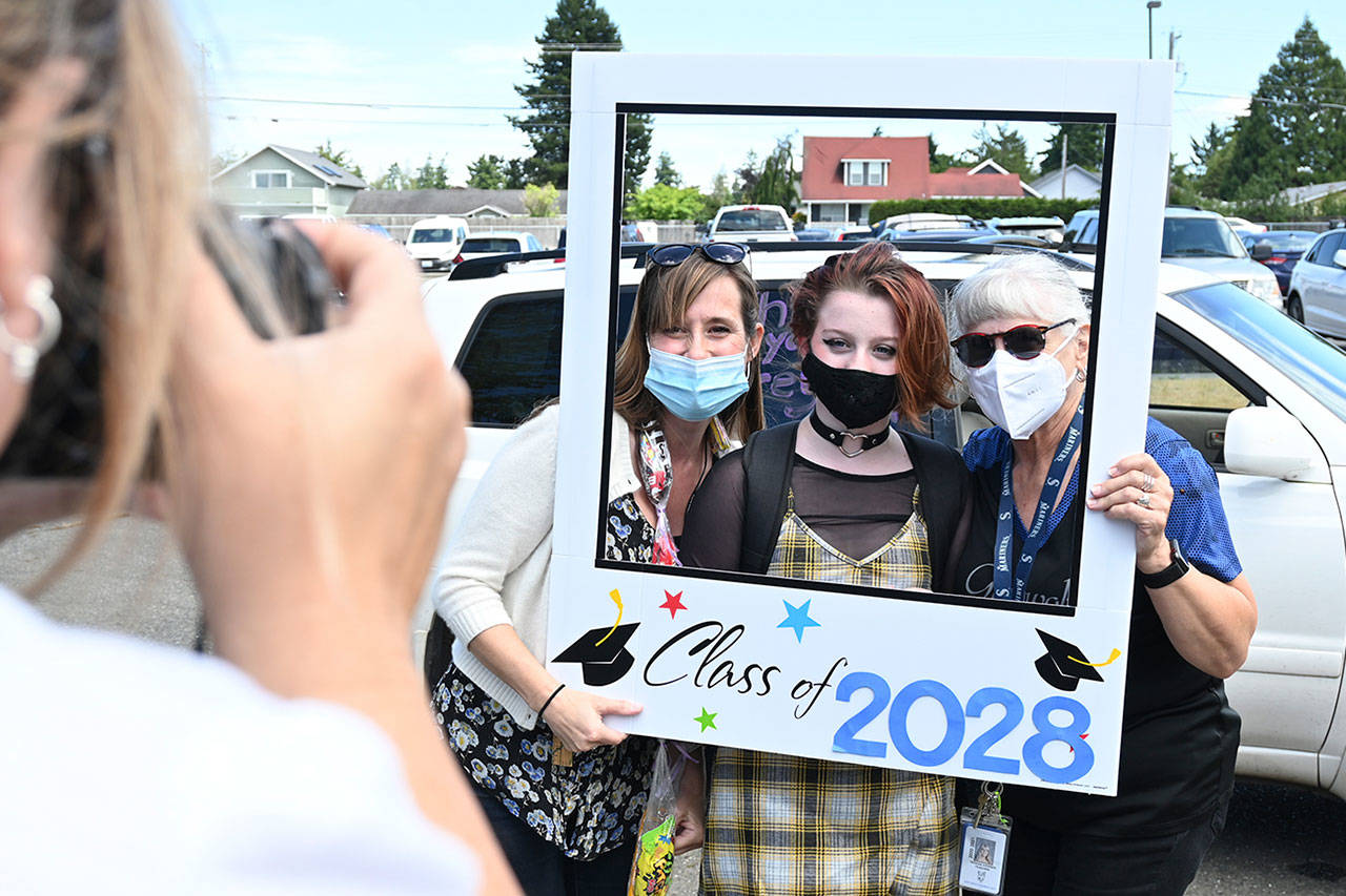 Fifth-grade teachers Nathalie Maynock, left, and Teresa Iversen celebrate Greywolf Elementary fifth-grader Joyce Caulfield on the school’s final in-person day on June 16.