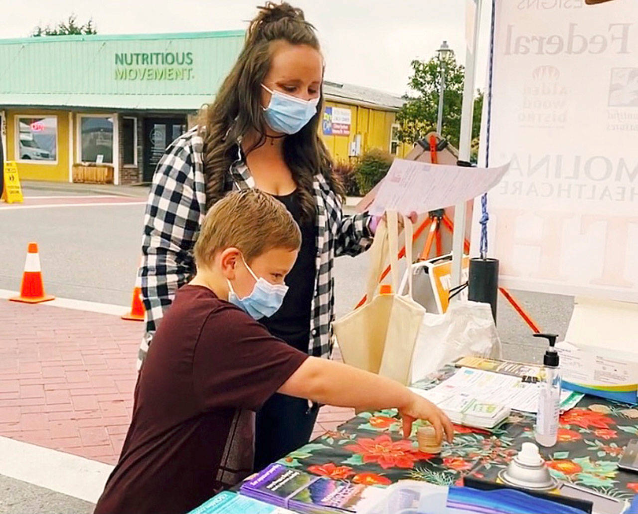 Rebecca and Abel, Sequim Farmers & Artisans Market’s SNAP ambassadors, redeem SNAP currency at the market. Photo by Emma Jane “EJ” Garcia