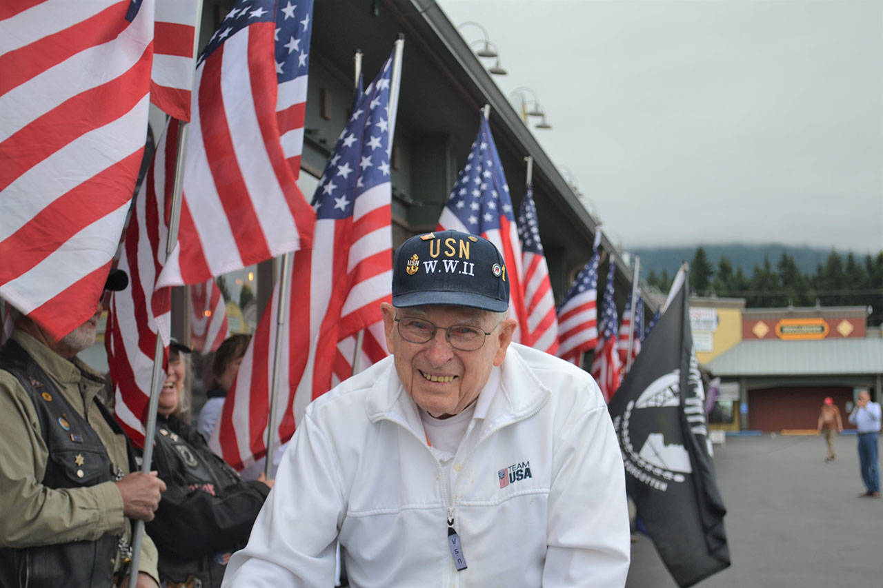 Allen Sill, a U.S. Navy and World War II veteran, walks the flag line presented in his honor recognizing his service on his 100th birthday. Submitted photo