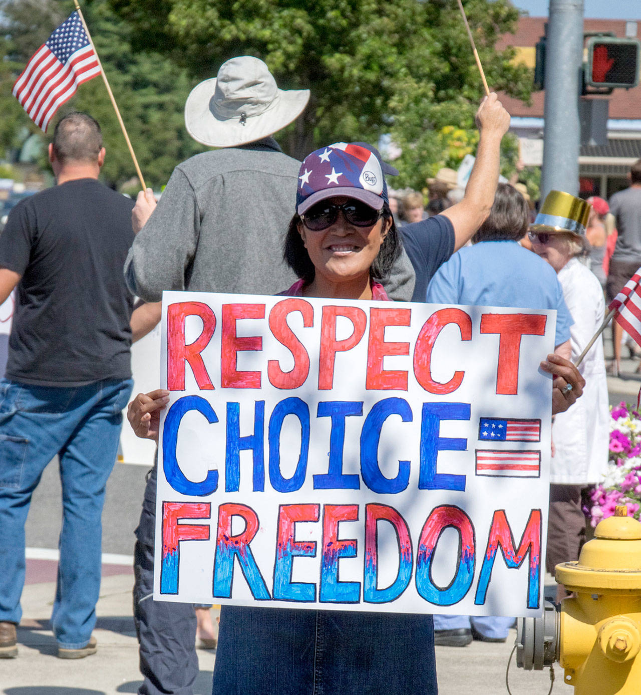 Chadley Klinger holds a handmade sign at the intersection of Sequim Avenue and Washington Street on Aug. 18, protesting the vaccine mandate for healthcare workers. “I don’t think that people’s livelihoods should be threatened by how they take care of their bodies,” Klinger said. Sequim Gazette photo by Emily Matthiessen