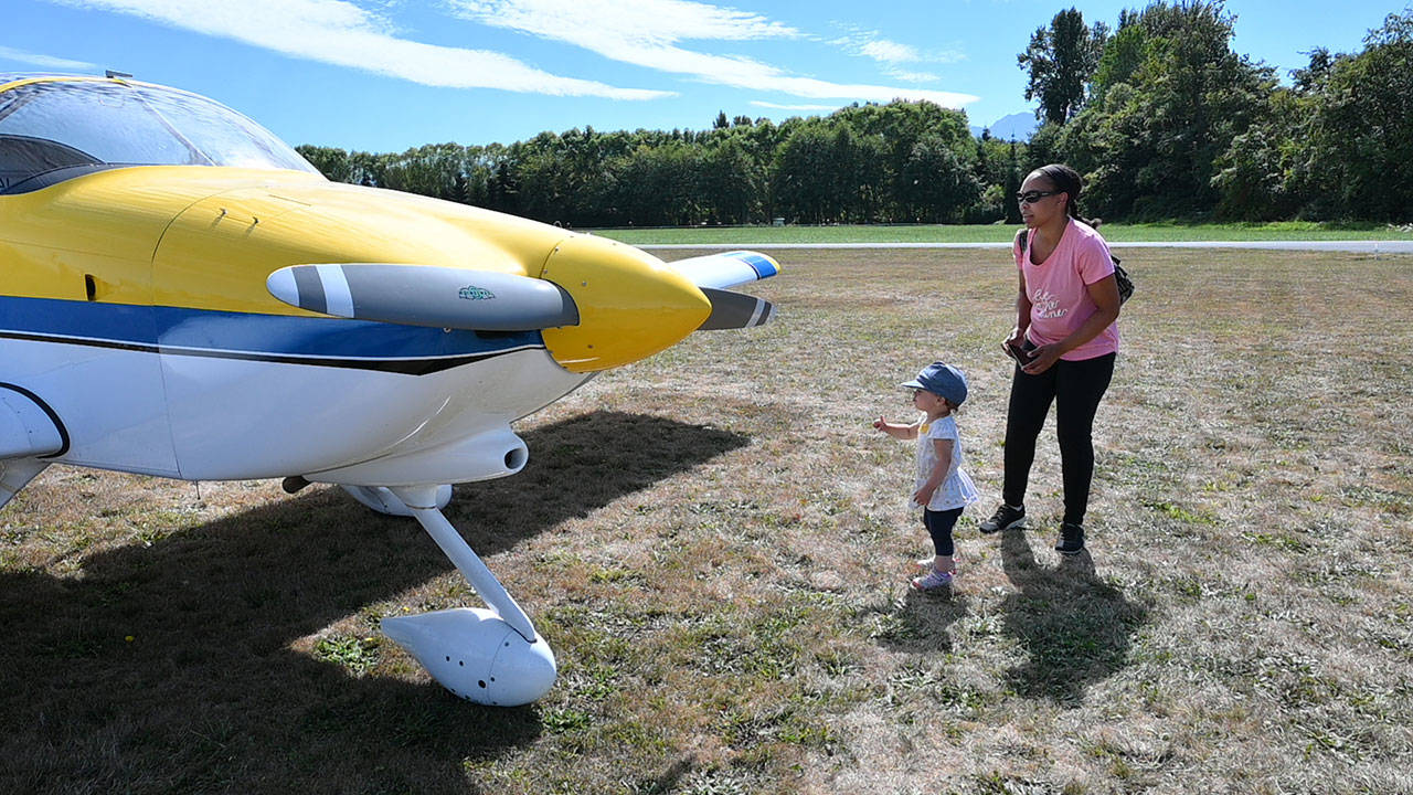 Kendall and nearly-2-year-old Kenna Huff of Snohomish get an up-close look at an RV-9A homebulit aircraft at the eighth Olympic Peninsula Air Affaire and Fly-In Saturday afternoon in Sequim. Sequim Gazette photo by Michael Dashiell