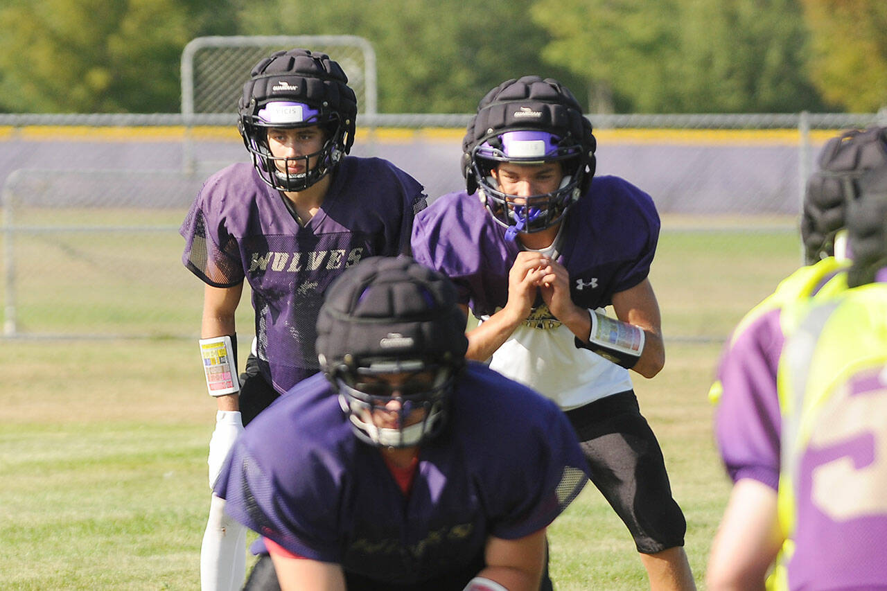 Sequim quarterback Kobe Applegate, right, and running back Aiden Gockerell await a snap in a preseason practice. The Wolves’ home opener on Sept. 10 against Squalicum is in jeopardy. Sequim Gazette file photo by Michael Dashiell