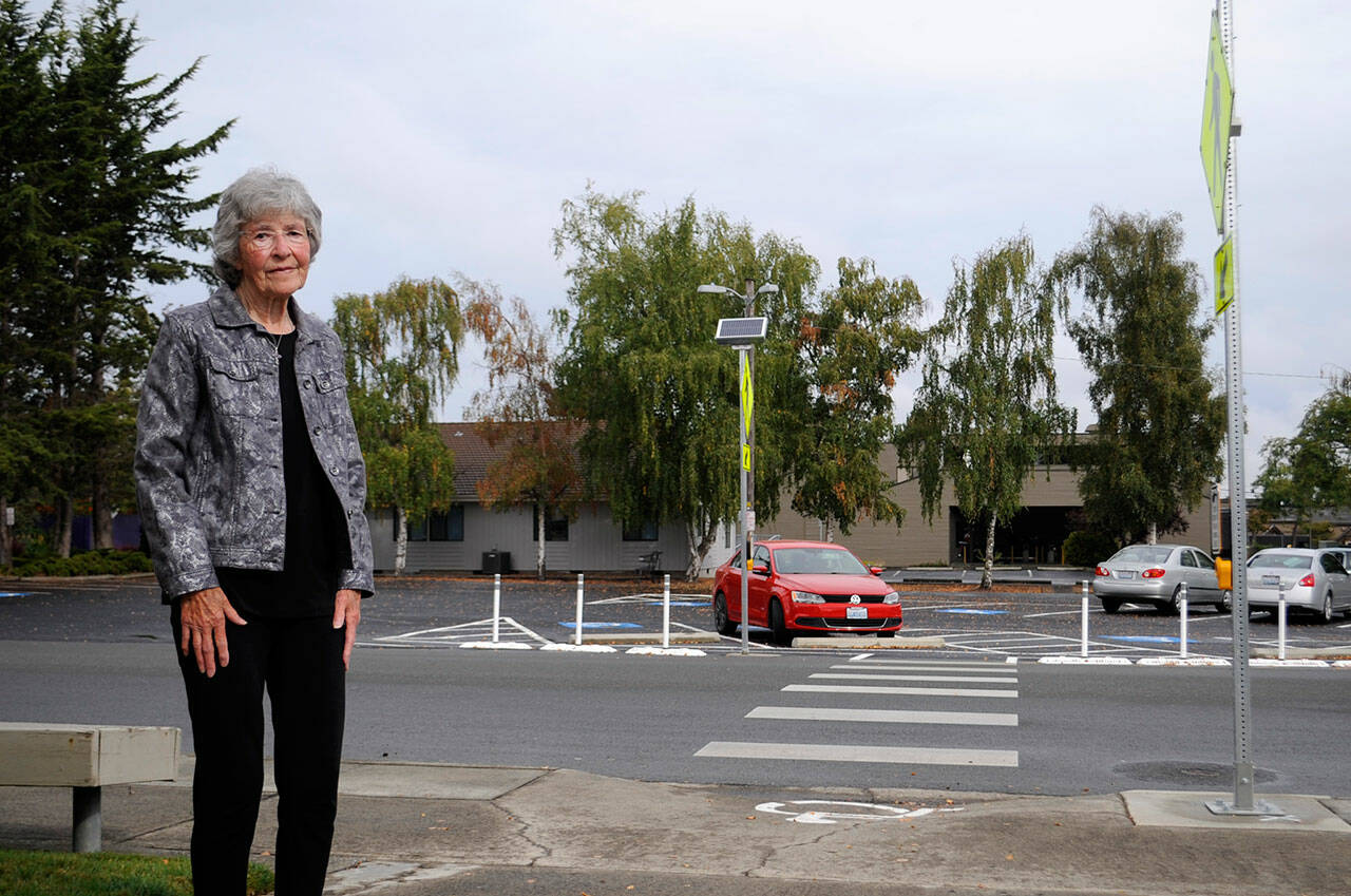 JoVonne Lingvall stands by a new pedestrian crosswalk at St. Joseph where she and her sister were struck by a vehicle last November. Lingvall survived, but her sister Lorraine (Reandeau) Anderson did not. “(The crosswalk) is well needed,” Lingvall said. “I felt the church and city did a good job. Too bad we didn’t have it sooner. She could still be alive.” Sequim Gazette photo by Matthew Nash