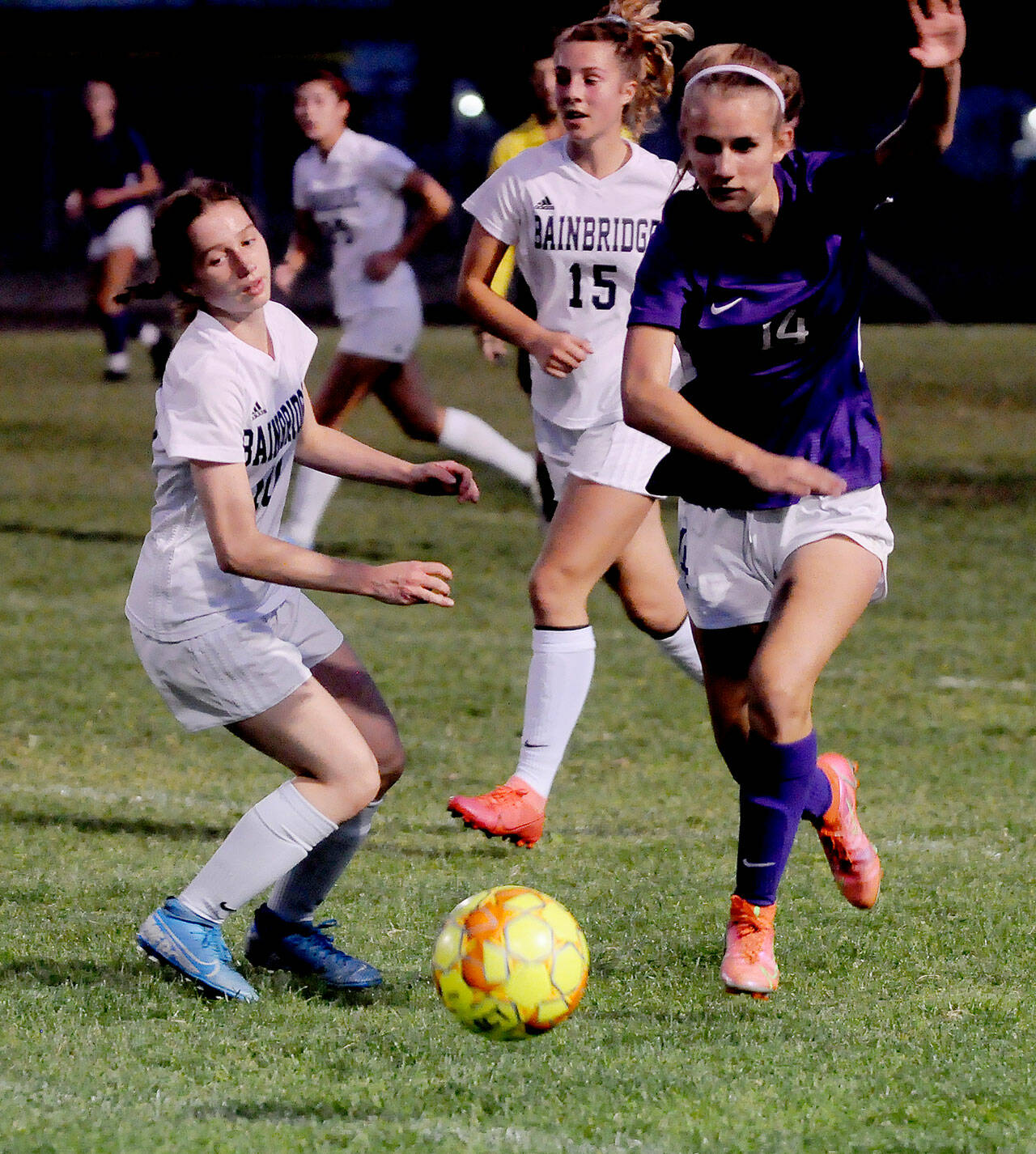 Sequim’s Hannah Wagner, right, advances the ball as the Wolves take on Bainbridge on Sept. 21 in Sequim, as Spartans Maddy Brown (10) and Savannah Mabee (15) look on. The Wolves held a 1-0 lead at halftime but fell to the visiting Spartans on penalty kicks. Sequim Gazette photo by Michael Dashiell