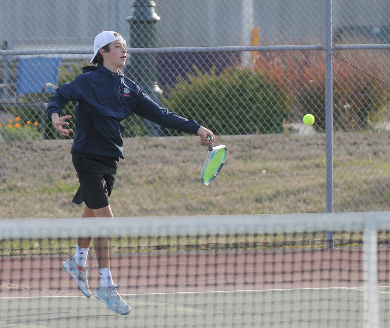 Sequim’s Garrett Little hits a return shot in the first set against Seth Fortenbacher of Kingston in a Sequim sweep of the Buccaneers on Oct. 7. Sequim Gazette photo by Michael Dashiell