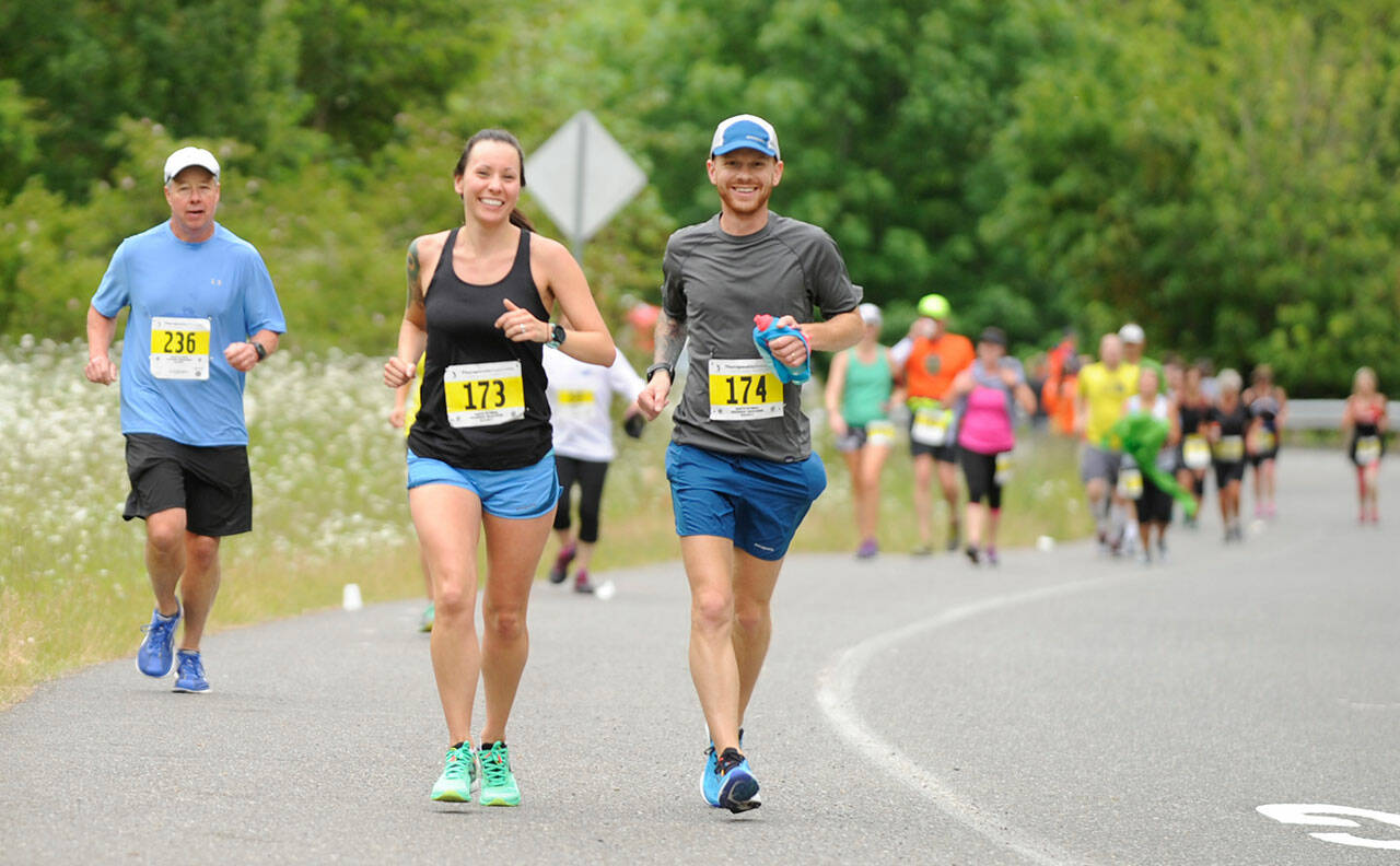 Alicia and Korey Konga of Yelm race down Whitefeather Way during the 2017 North Olympic Discovery Marathon. Sequim Gazette file photo by Michael Dashiell