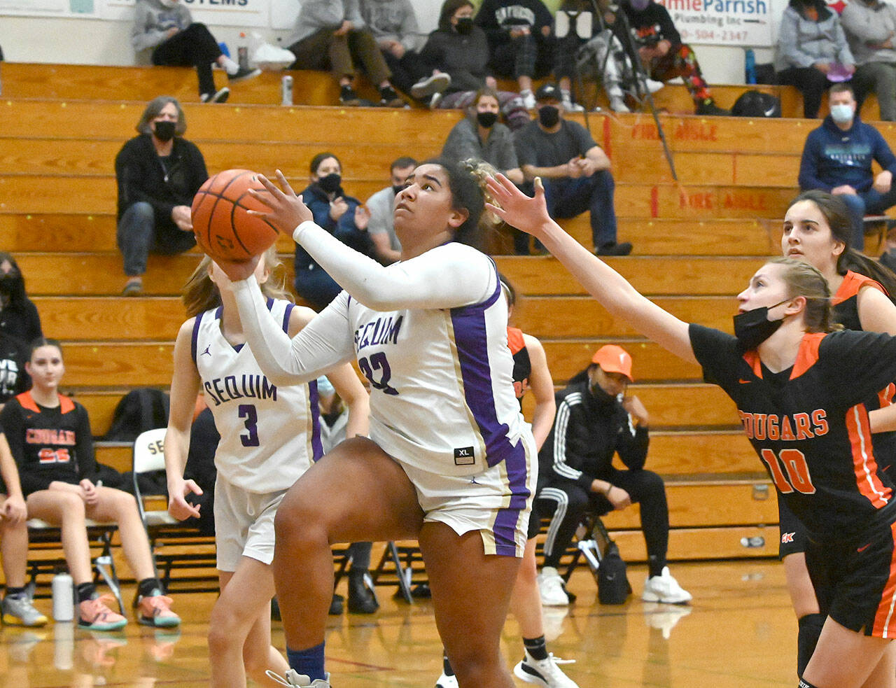 Sequim’s Jelissa Julmist drives past Central Kitsap’s Ella Baungartner for a basket in the Wolves’ match-up with the Cougars on Dec. 13. Sequim Gazette photo by Michael Dashiell