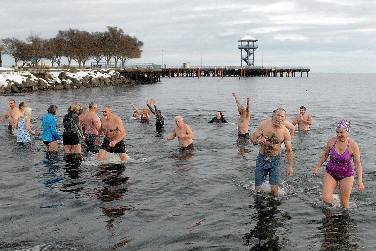 Polar bear dippers wade in and out of the chilly water at Hollywood Beach in Port Angeles during Saturday’s annual New Year’s Day plunge. Dozens of people braved sub-freezing air temperatures to ltake part in the ritual that also was undertaken by others on the North Olympic Peninsula at Lake Pleasant and Nordland. Photo by Keith Thorpe/Olympic Peninsula News Group