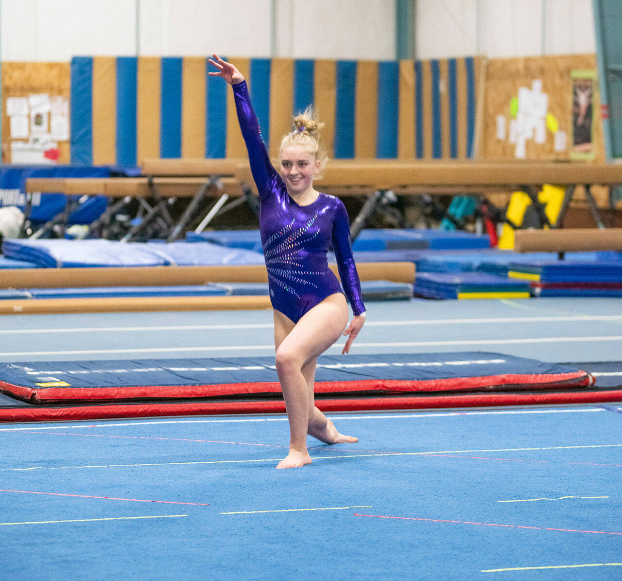 Sequim High senior Alex Schmadeke smiles after finishing her floor exercise at an Olympic League meet on Jan. 19 in Port Angeles. Sequim Gazette photo by Emily Matthiessen