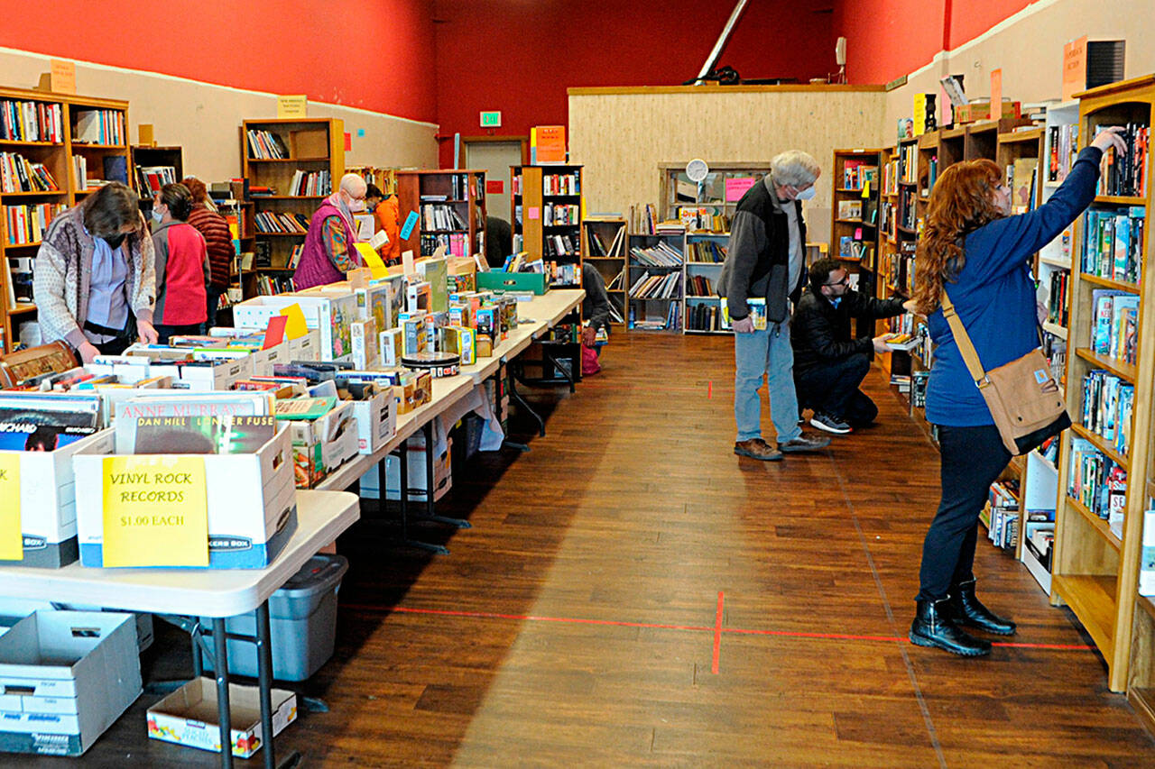 Hours after the Clallam County public health order was lifted for COVID-19 protocols starting on Saturday, March 12, the Friends of Sequim Library held its regularly scheduled monthly book sale at Rock Plaza. Volunteers said there was a mix of people choosing to wear masks and not. Sequim Gazette photo by Matthew Nash