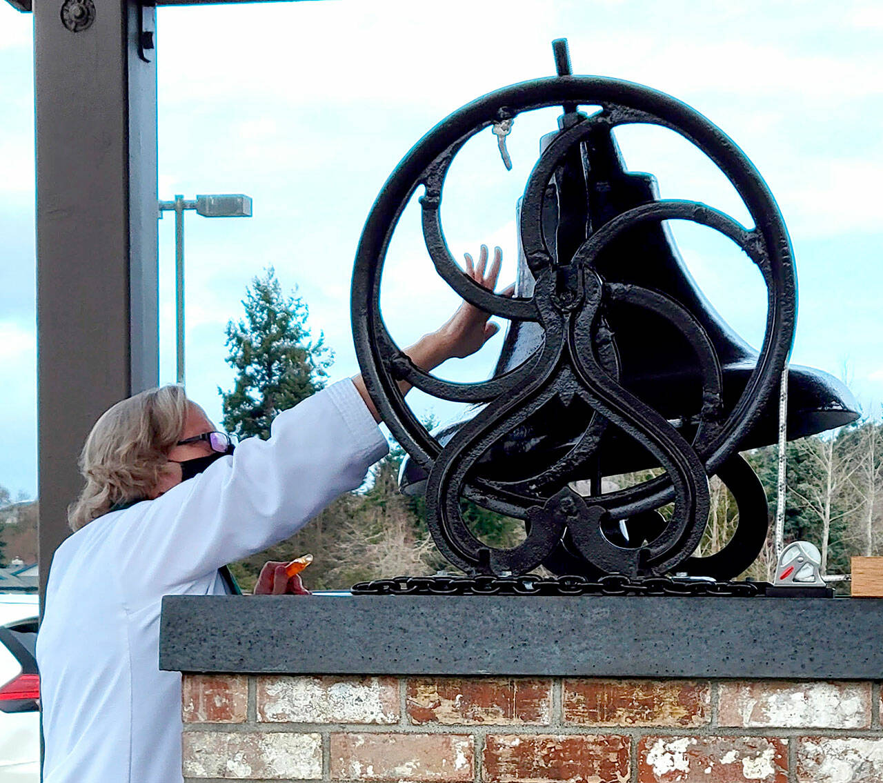 Pastor Joey Olsen blesses the 19th-century bell at Trinity United Methodist Church in February.