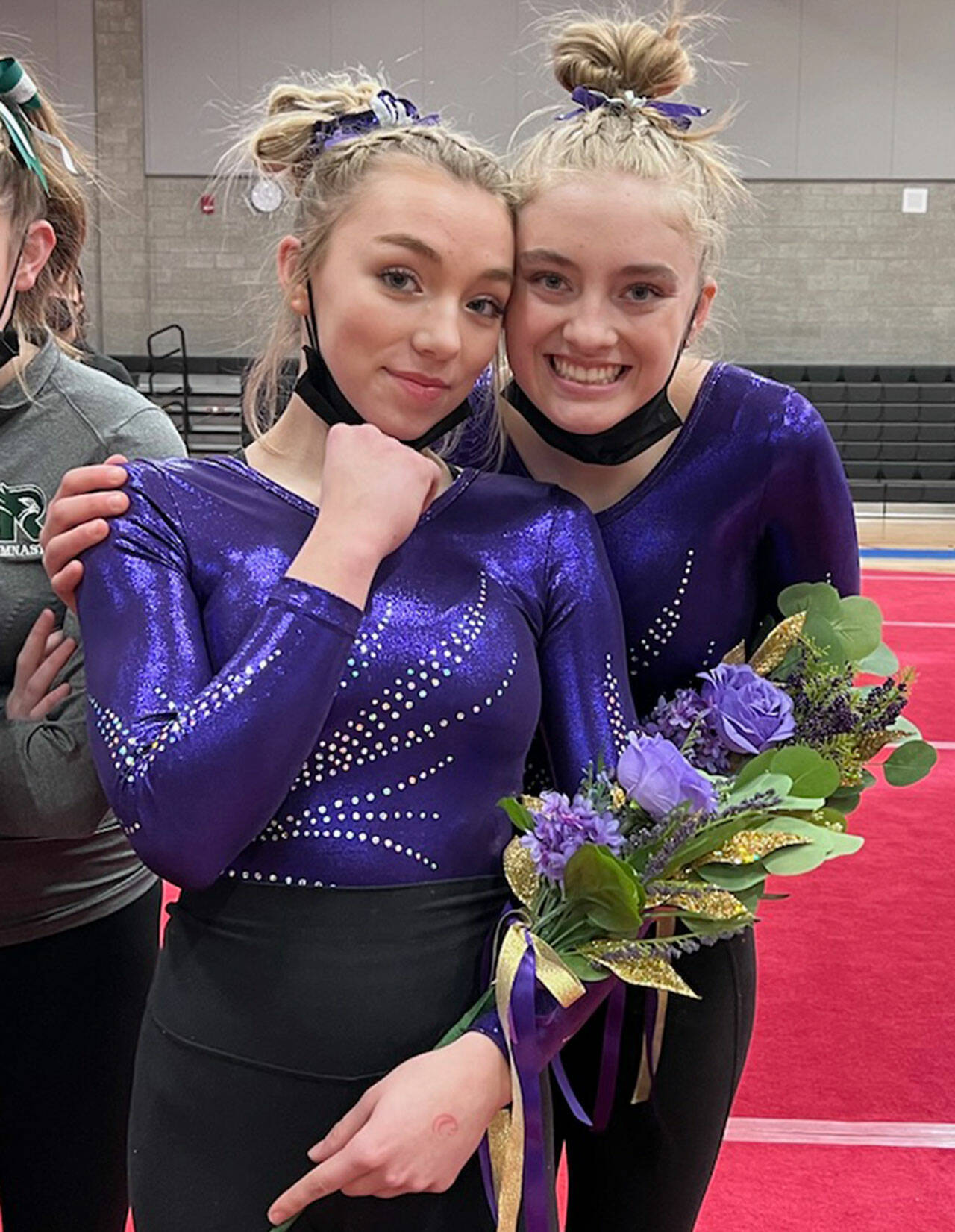 Submitted photo
Sequim High sophomore Susannah Sharp, left, and senior Alex Schmadeke take a break from the action at the Washington state 2A/3A gymnastics meet this past weekend.