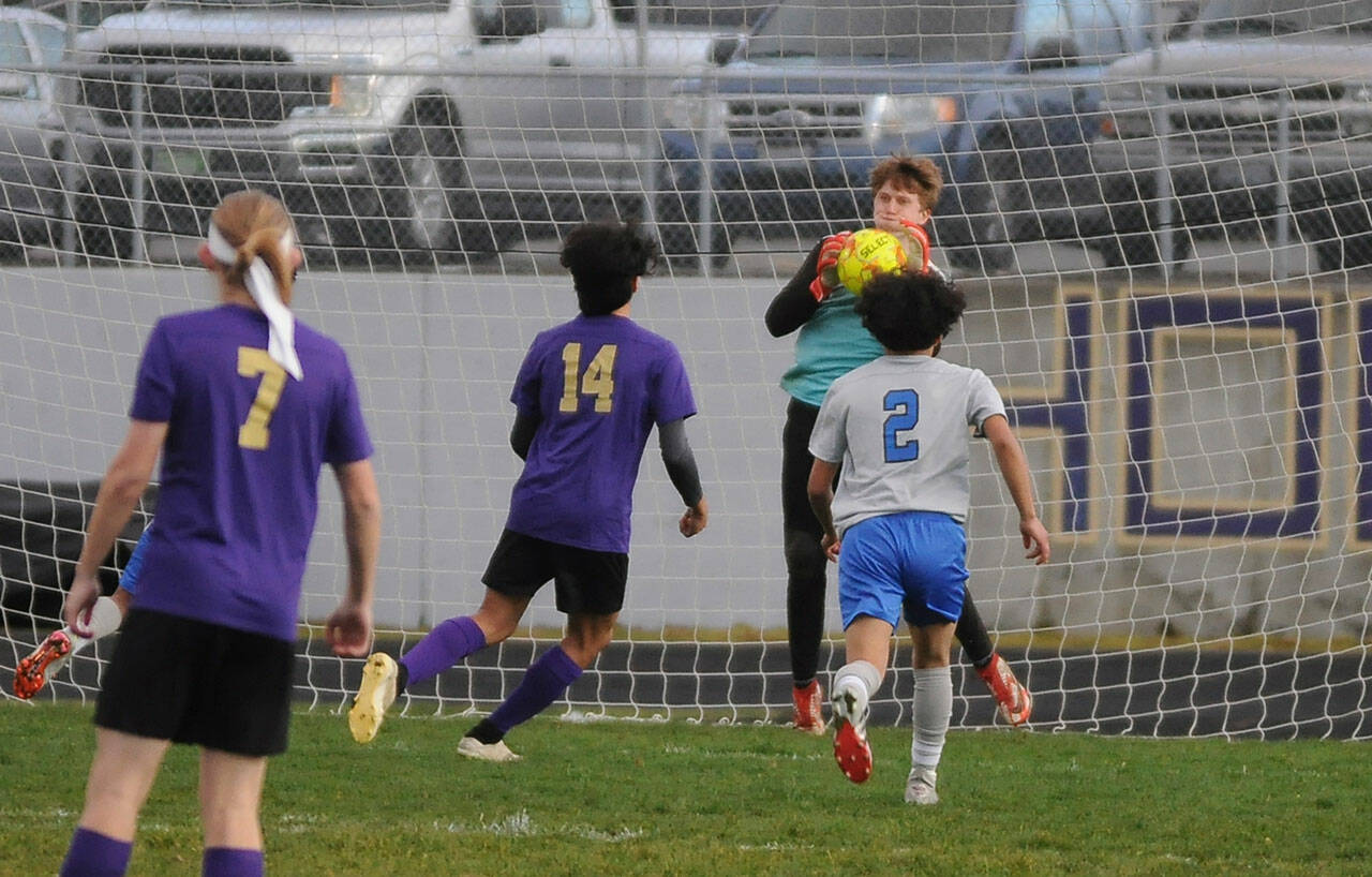 Sequim goalkeeper Jack Van De Wege makes a save in the Wolves' home opener, a 4-0 win over North Mason on March 15. Sequim Gazette photo by Michael Dashiell