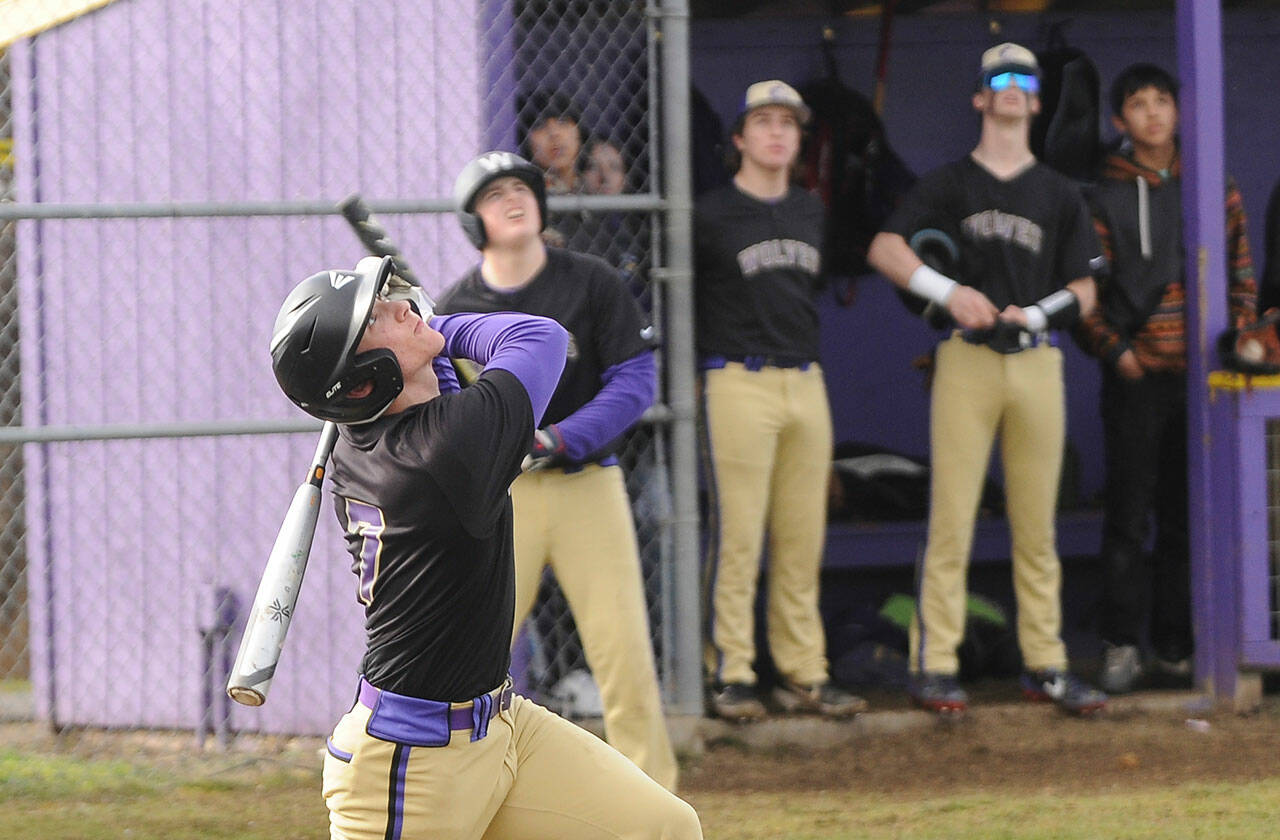 As teammates look on, Sequim’s Conor Bear skies a popup in the first inning of the Wolves’ league opener against Bainbridge in March 15. The Wolves took an early 2-0 lad but fell to the 3A Spartans, 22-22. Sequim also dropped a 22-2 game at league foe Bremerton on March 17 and a 10-0 decision to 1A Forks on March 18. Sequim (0-3) was slated to host North Kitsap on March 22; results were not available at press time. The Wolves are at North Mason on March 24 and at Anacortes on March 26 before hosting Kingston on March 28. Sequim Gazette photo by Michael Dashiell