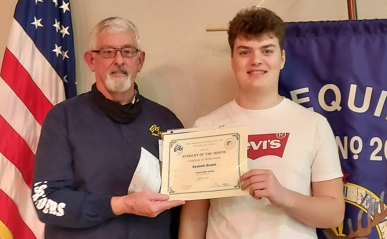 Sequim High School sophomore Keenan Green, right, accepts his Student of the Month honor (March 2022) from Sequim Elks Leading Knight Stan Dame.