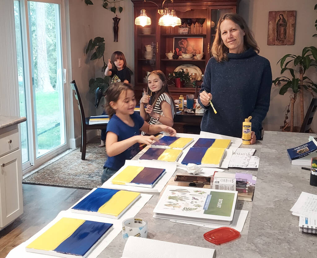 Photo courtesy of Kyle Johnson
Josephine Johnson, second from right, and family get to work on her artwork fundraiser to aid refugees from the Russian invasion of Ukraine.