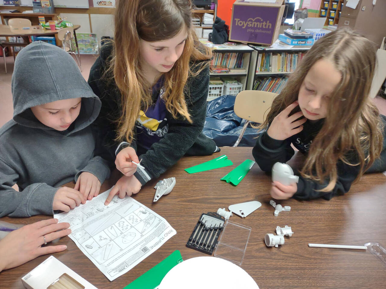 Submitted photo
Students at Helen Haller Elementary School — from left, Tyler Speed, Selene Dorkin and Ellie Roedell — build wind turbines in a lesson about wind power and layers of soil.