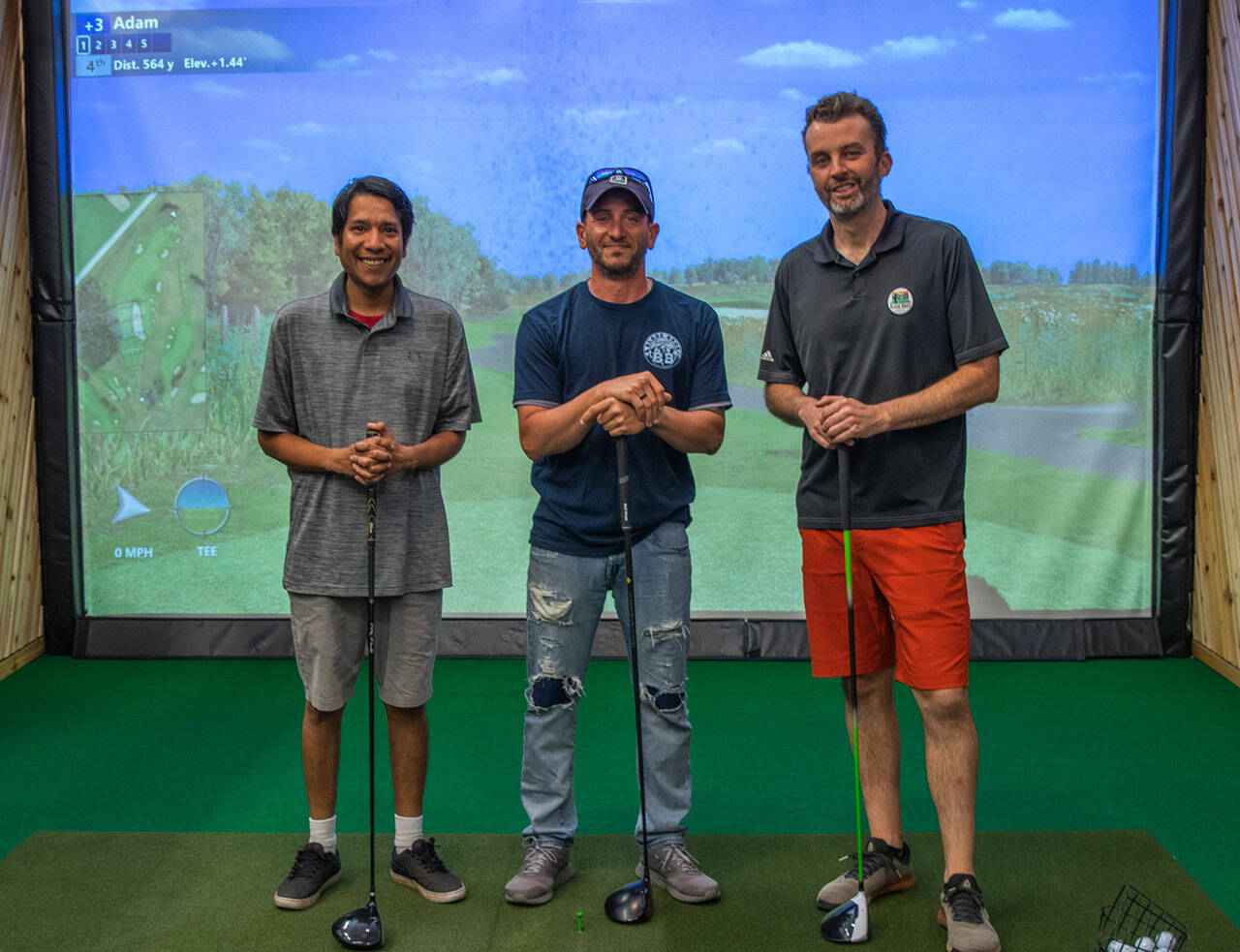 Sequim Gazette photo by Emily Matthiessen/ From left, Ryan Beyale, Derek Moore and Brandon Lancelle are three of the golf friends who have banded together to bring Blade Bros Golf Club to Sequim and the surrounding area. With 24 hour access, members of their club can practice golf on simulations of more than 70 real and imaginary courses no matter the weather, time of year or day. They say that indoor golf is perfect for those of limited mobility, beginners, families who enjoy miniature golf, and anyone who wants to practice their swing according to their own schedule.