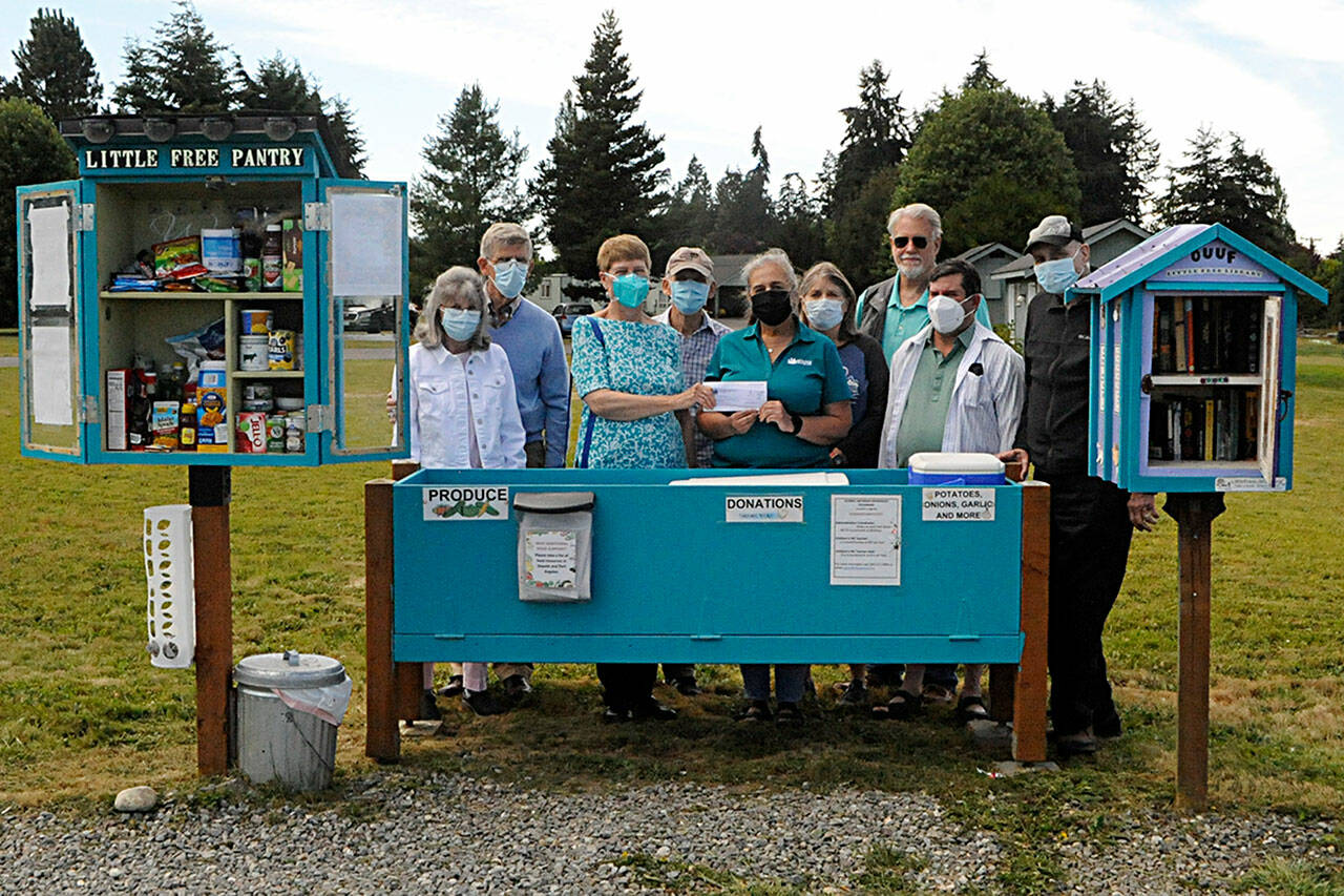 Sequim Gazette photo by Matthew Nash
Agnew Little Free Pantry volunteers greet Sara Irish, a Molina Healthcare community engagement specialist, fifth from left, as she donates $2,000 for food from the agency. Some of the volunteers who work daily to restock the pantry, include, from left, Susan Harris, Dave Large, Florence and Michael Bucierka, Irish, Peggy and John Toppenberg, Dave Iezzi, and Ren Garypie.