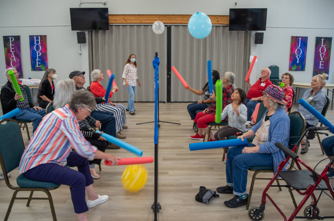 Sequim Gazette photo by Emily Matthiessen / Volunteers and people living with memory loss play a variation of balloon volleyball during a Tim’s Place gathering at Trinity United Methodist Church in Sequim.