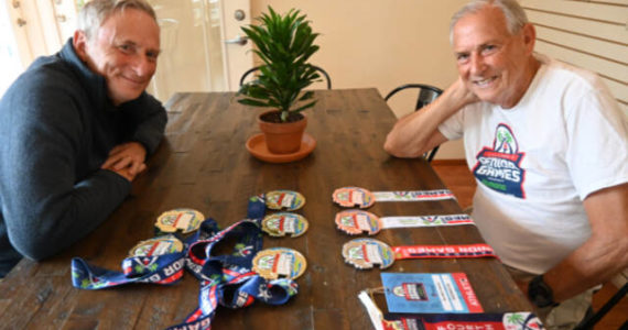 Sequim Gazette photo by Michael Dashiell / Phil Milliman, left, and his father Chuck display some of the many medals they earned at the 2022 National Senior Games.