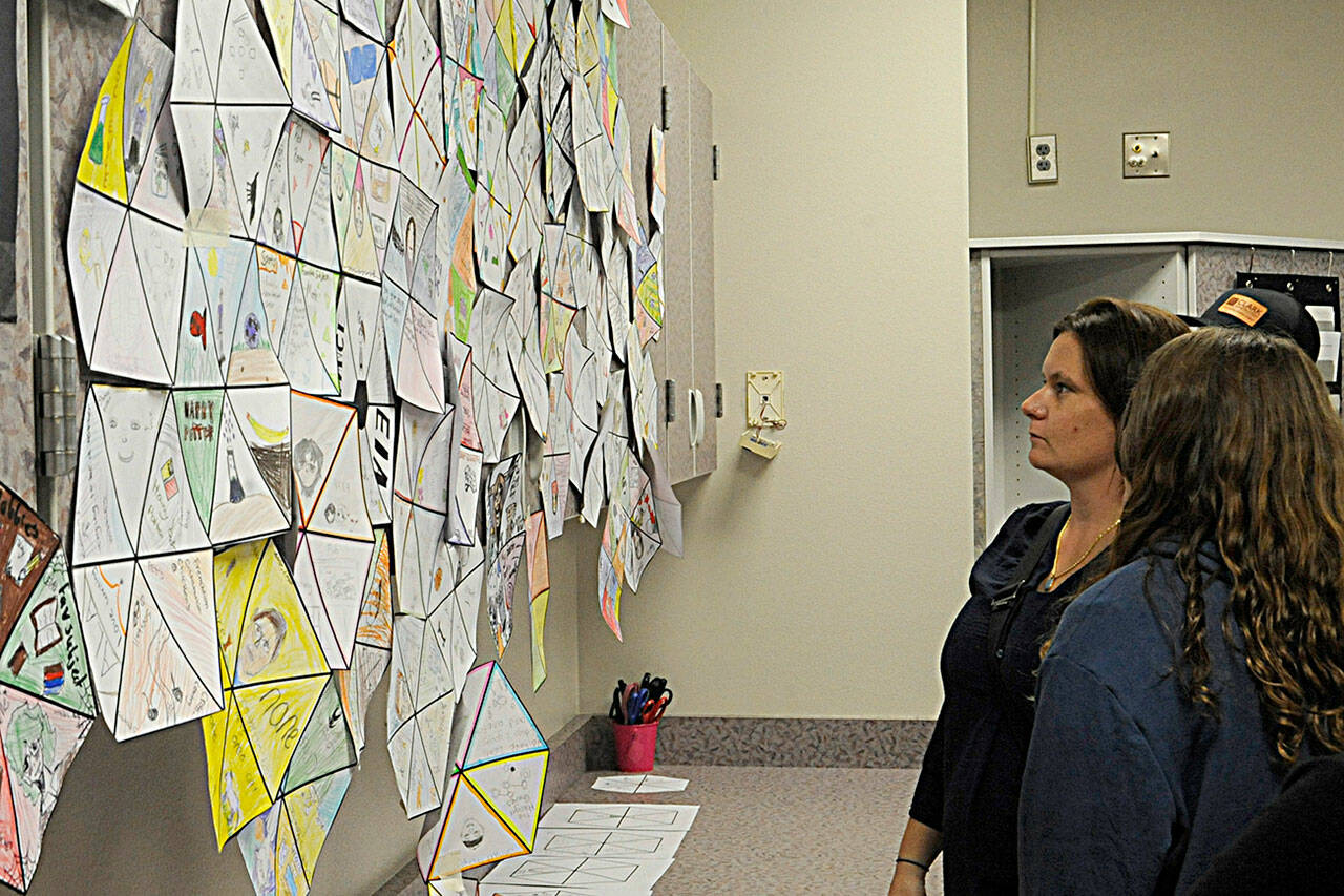 Katie Smith looks for her daughter Aliya’s “All About Me” project in Cheryl Eekhoff’s seventh grade accelerated seventh grade English Language Arts’ class during Back to School Night at Sequim Middle School.