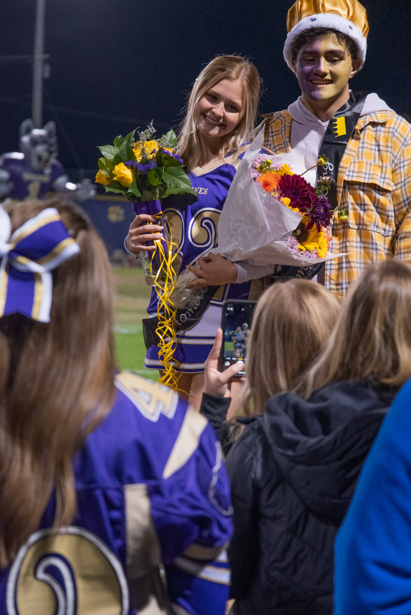 Sequim Gazette photo by Emily Matthiessen / Friends celebrate Sequim High’s 2022 Homecoming Queen and King, Claire D’Amico and Aaron Tolberd, at halftime of the SHS football game on Sept. 30.