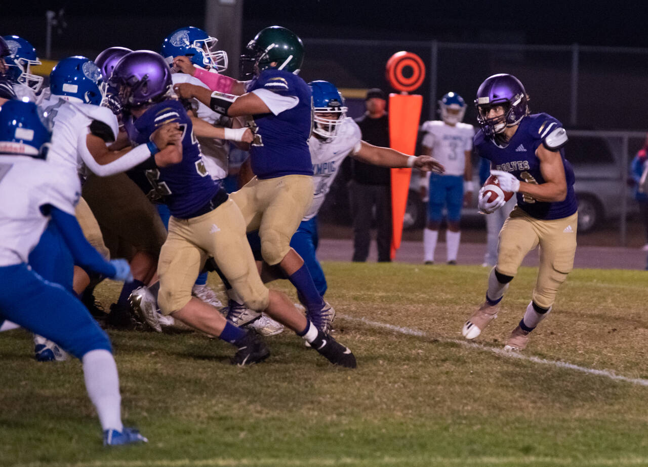 Sequim Gazette photo by Emily Matthiessen
Sequim running back Aiden Gockerell looks for running room in the Wolves’ 35-21 loss to Olympic on Oct. 7. Gockerell had more than 150 yards rushing.