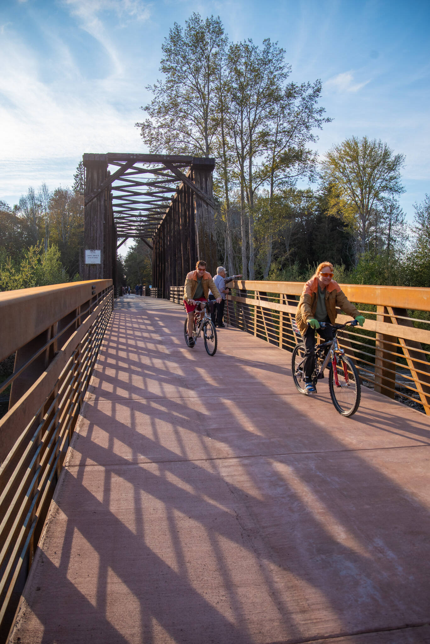 Sequim Gazette photo by Emily Matthiessen 
Pedestrians and bicyclists last week check out the newly-reopened bridge at Railroad Bridge Park, part of the Olympic Discovery Trail.