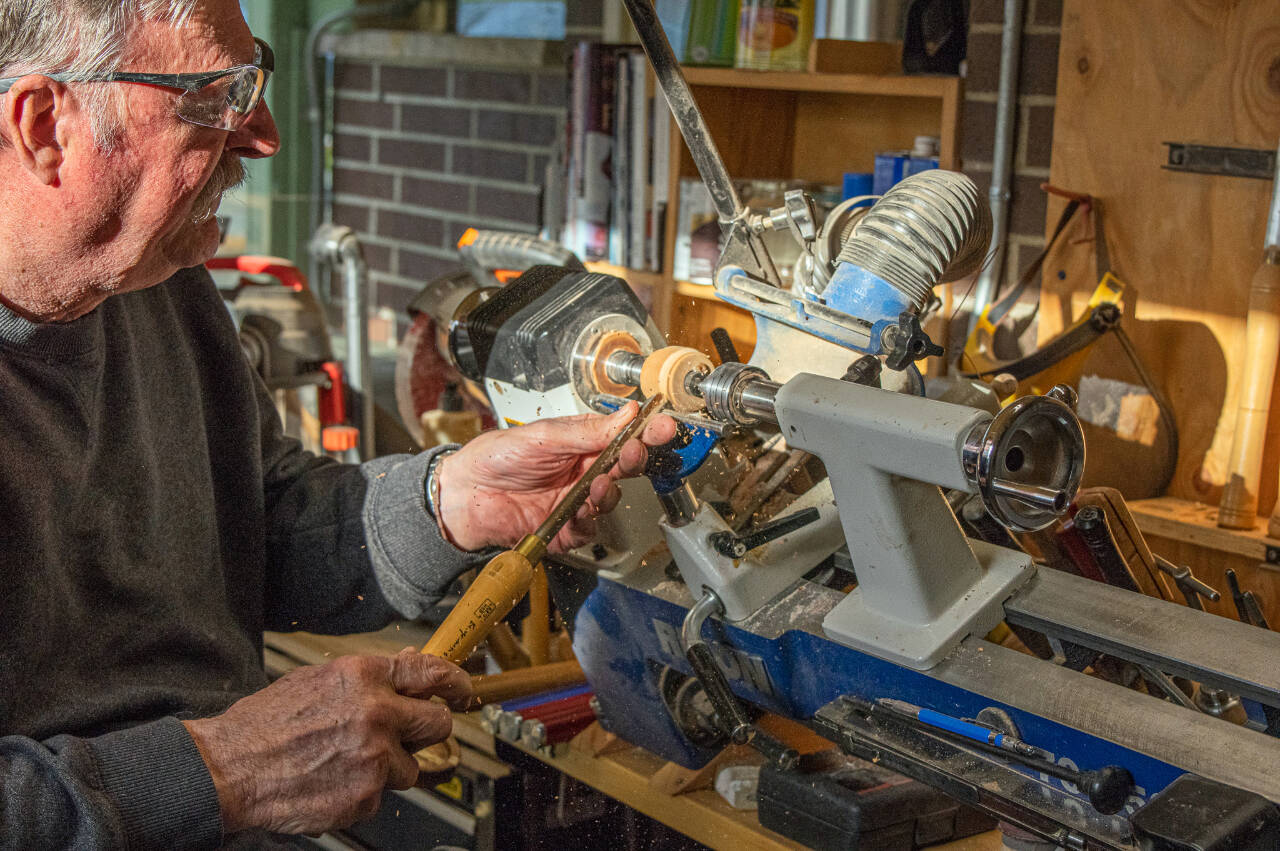 Sequim Gazette photo by Emily Matthiessen / Sequim resident Dave Sellman, five-year member of the Strait Turners, works at a lathe that he set up at an angle so that he could turn wood in his wheelchair. He says that wood turning is accessible for many people who have physical restrictions or space restrictions. His shop is small but contains all the equipment he needs to turn out beautiful pieces that he gives to his loved ones or sells at Shipley Center events, donating all proceeds to charity, especially the VOHCC. He says, “I hope that other wheelchair bound individuals will realize that they can be creative and stretch their boundaries.”