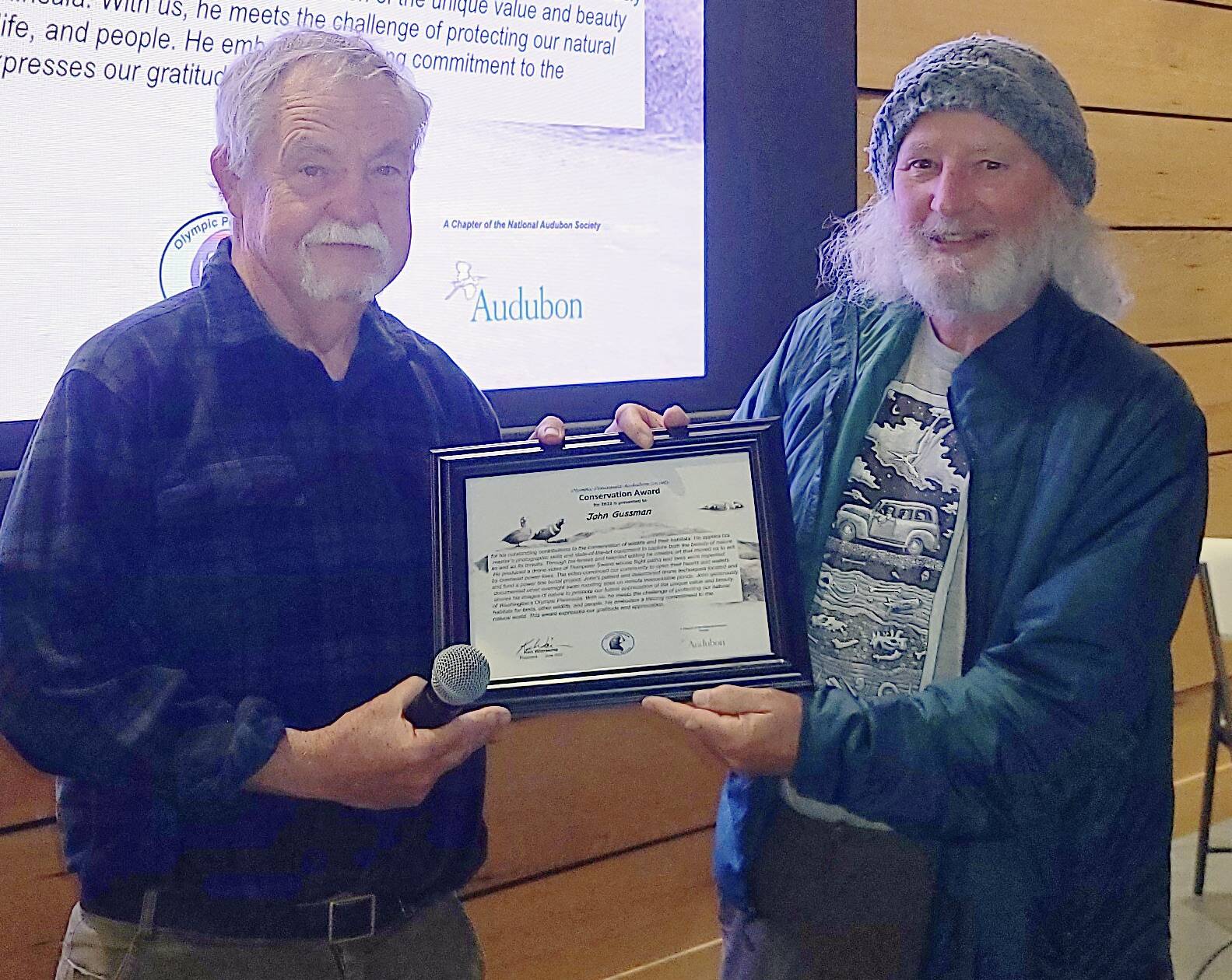 Photo by Dee Renee Ericks / At right, John Gussman receives the Olympic Peninsula Audubon Society’s 2022 Conservation Award from Audubon Chapter Conservation Chair Bob Phreaner in mid-October.