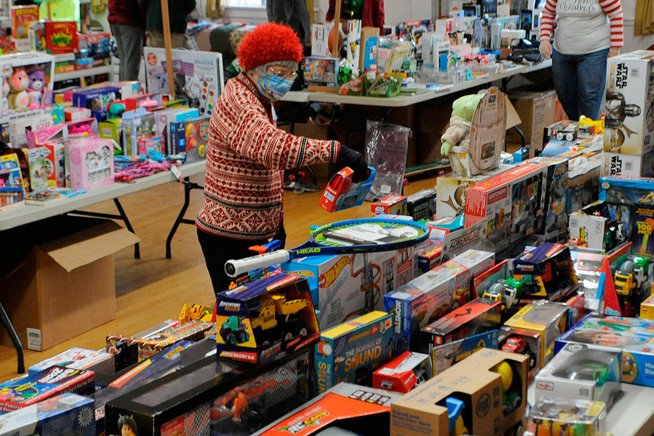 Matthew Nash/Sequim Gazette file photo
Volunteer Pat Gritman sorts toys at last year’s Toys for Sequim Kids event. The annual event returns Dec. 14 to the Sequim Prairie Grange with donations accepted throughout the area through Dec. 12.