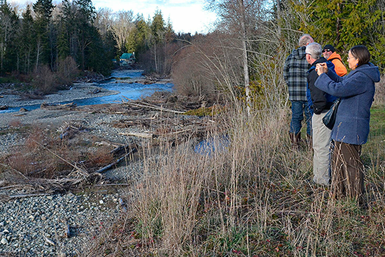 Sequim Gazette file photo by Matthew Nash Visitors look at the Dungeness River near the site in 2017 where Clallam County officials continue to seek support for the Dungeness Off-Channel Reservoir.